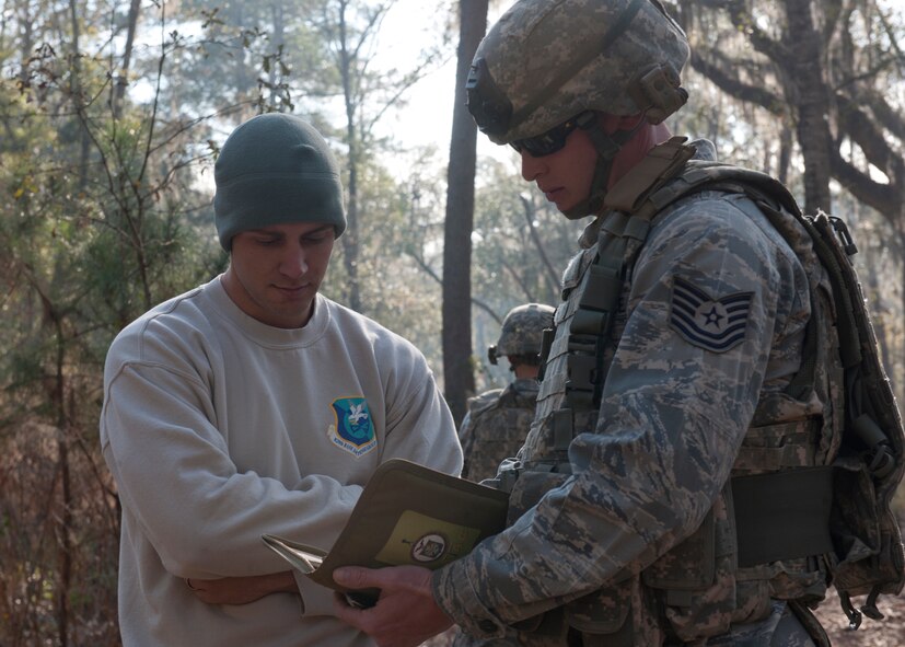 U.S. Air Force Tech. Sgt. Dallas Bozeman, 820th Combat Operations Squadron explosive ordnance disposal technician (left), evaluates a plan of action during a counter improvised explosive device tactical training situation at the military operations in urban terrain village Feb. 8, 2012 at Moody Air Force Base, Ga. Bozeman works as an instructor for the 820th COS and was recently selected to receive the Maj. Gen. Eugene A. Lupia non-commissioned officer category award at both the Air Combat Command and Air Force level. (U.S. Air Force photo by Senior Airman Eileen Meier/Released)