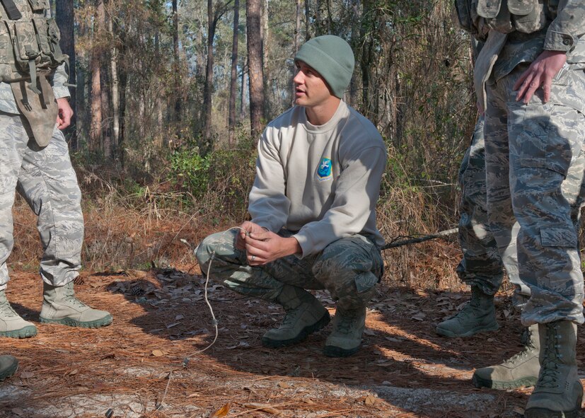 U.S. Air Force Tech. Sgt. Dallas Bozeman, 820th Combat Operations Squadron explosive ordnance disposal technician, shows other members of his squadron how to identify an improvised explosive device during field training at the military operations in urban terrain village Feb. 8, 2012, at Moody Air Force Base, Ga. Bozeman was recently deployed to Afghanistan and was recognized for his job performance as an by receiving the Maj. Gen. Eugene A. Lupia non-commissioned officer category award. Bozeman also received a Bronze Star Medal in April of 2011 for past missions down range. (U.S. Air Force photo by Senior Airman Eileen Meier/Released)