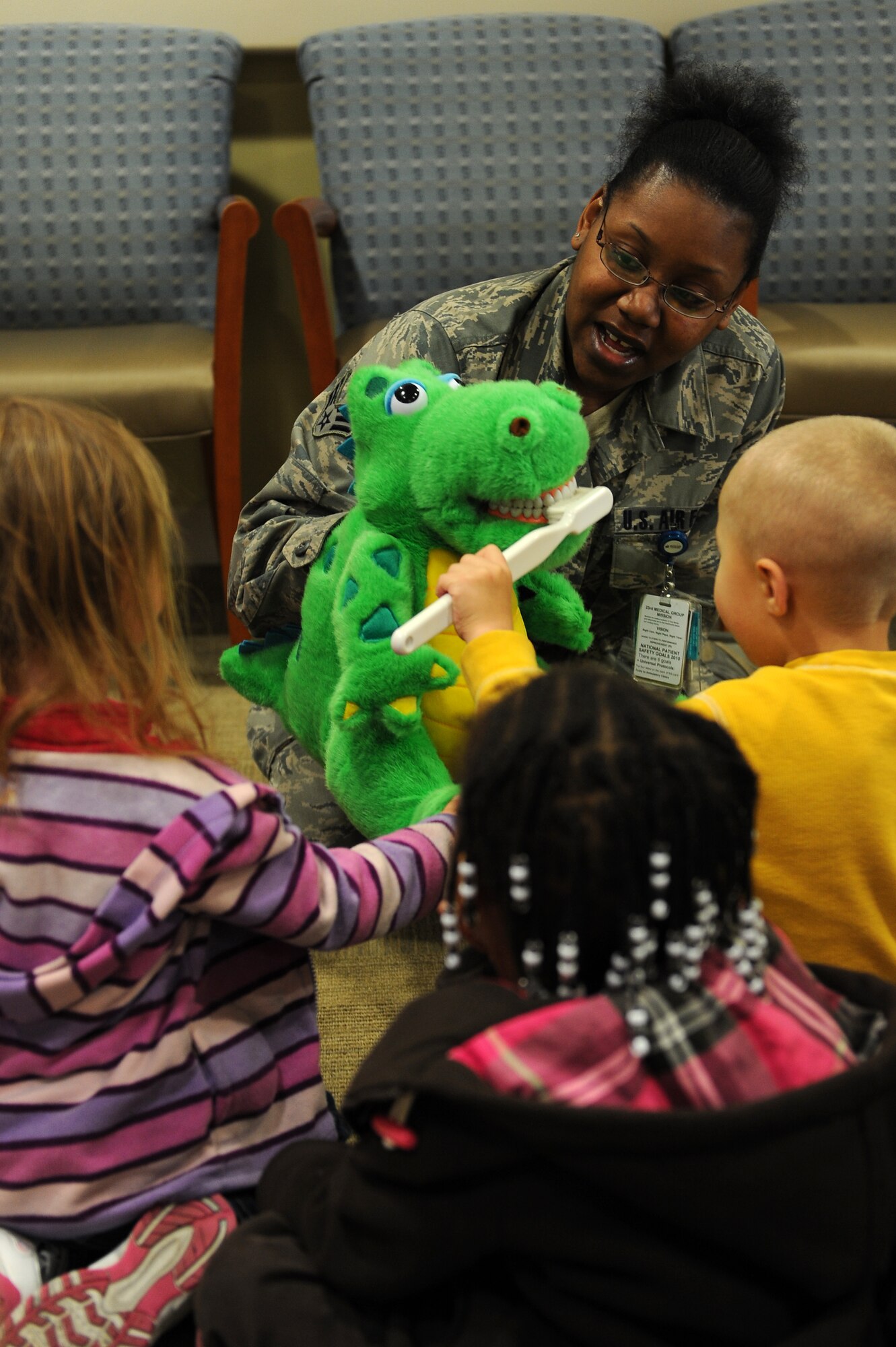 U.S. Air Force Senior Airman Jackie Williams, 23d Aerospace Medicine Squadron dental technician, shows children from the Child Development Center how to properly brush teeth at Moody Air Force Base, Ga., Feb. 8, 2012.  With February being National Children’s Dental Health Month, the children visited the dental clinic to learn about dental health and the importance of keeping their teeth cleaned. (U.S. Air Force photo by Staff Sgt. Ciara Wymbs/Released)