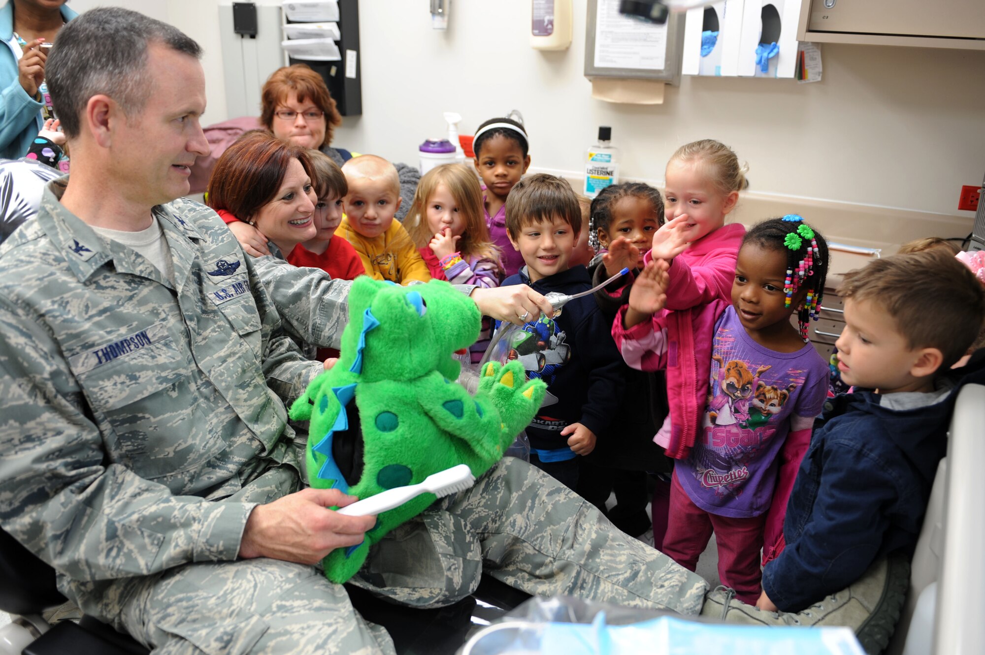 U.S. Air Force Col. Billy Thompson, 23d Wing commander, interacts with children visiting the dental clinic from the Child Development Center at Moody Air Force Base, Ga., Feb. 8, 2012. The visit informed children on the importance of dental visits and to make them more comfortable with having their teeth cleaned. (U.S. Air Force photo by Staff Sgt. Ciara Wymbs/Released)
