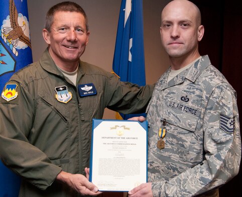 Tech. Sgt. Matthew Kurpaski, right, receives an Air Force Commendation Medal from Air Force Academy Superintendent Lt. Gen. Mike Gould in a presentation Feb. 1, 2012. Kurpaski, the NCO in charge of aircrew flight equipment for the 306th Operations Support Squadron, received the medal for taking charge of an accident scene and treating one person who was wounded. Kurpaski is a native of Santa Monica, Calif. (U.S. Air Force photo/Don Branum)