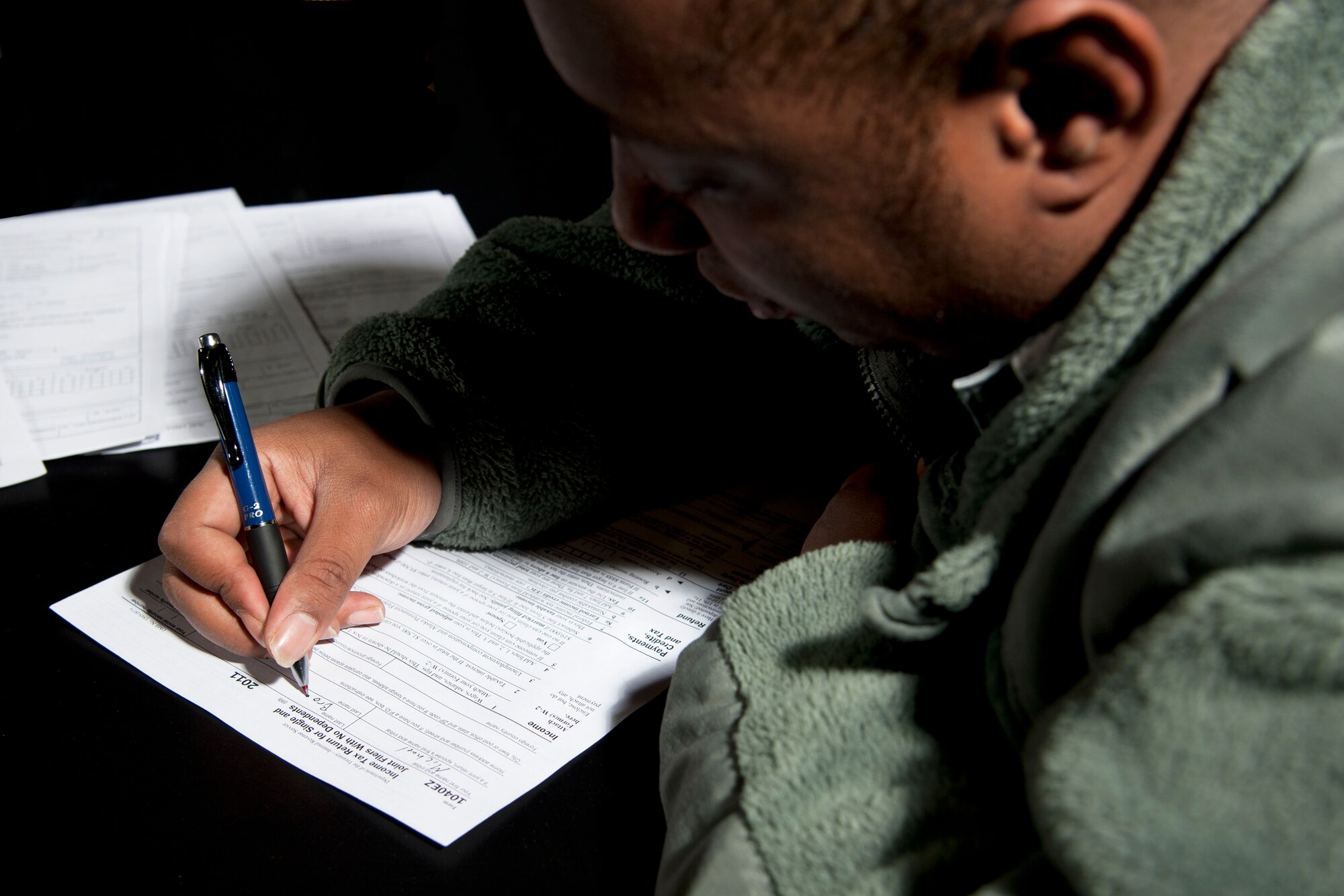 Senior Airman Michael Brooks, 49th Logistics Readiness Squadron, attempts to file his 2011 taxes on his own. Brooks could have saved himself a lot of time and energy by filing his taxes with the Holloman Tax Center located in the Community Activities Center on base. (U.S. Air Force Photo illustration by Airman 1st Class Anthony M. Ward)