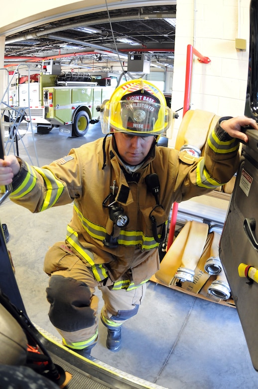 Firefighter David Wise, in full personal protective equipment, climbs aboard a fire truck in response to an exercise at Joint Base Charleston – Weapons Station, Feb. 2. The exercise was held to test the unit’s response time as well as simulate fighting a fire at a home in the MenRiv Housing area. Wise is a firefighter assigned to the 628th Civil Engineer Squadron, Civil Engineer Fire Department. (U.S. Navy photo/Petty Officer 1st Class Jennifer Hudson)