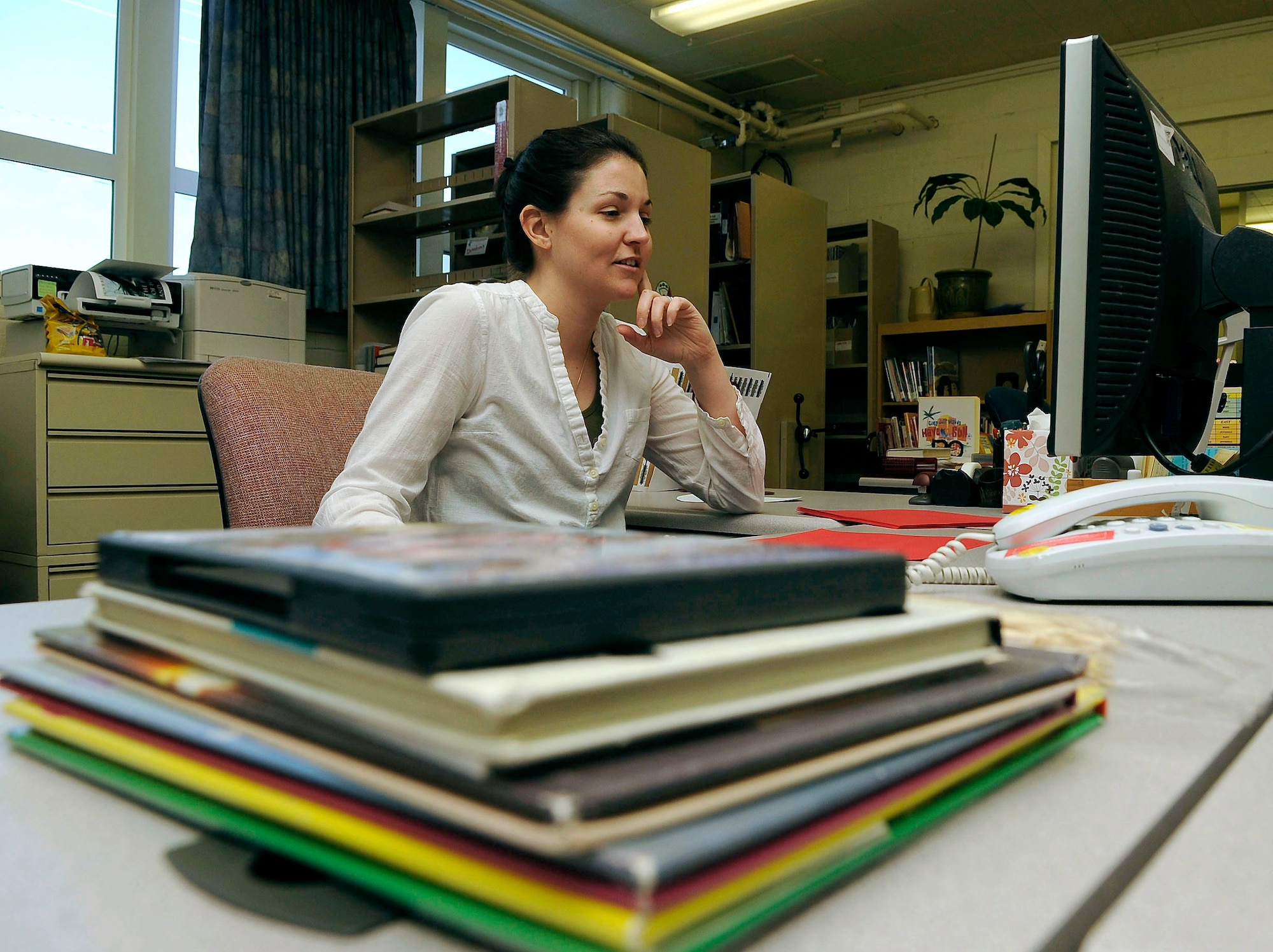 Sarah Maurath reads over the library catalog while sorting through returned books at the Eielson Air Force Base Library Feb. 6, 2012. Maurath is a library technician assigned to the 354th Force Support Squadron. (U.S. Air Force photo by Airman 1st Class Zachary Perras/Released)