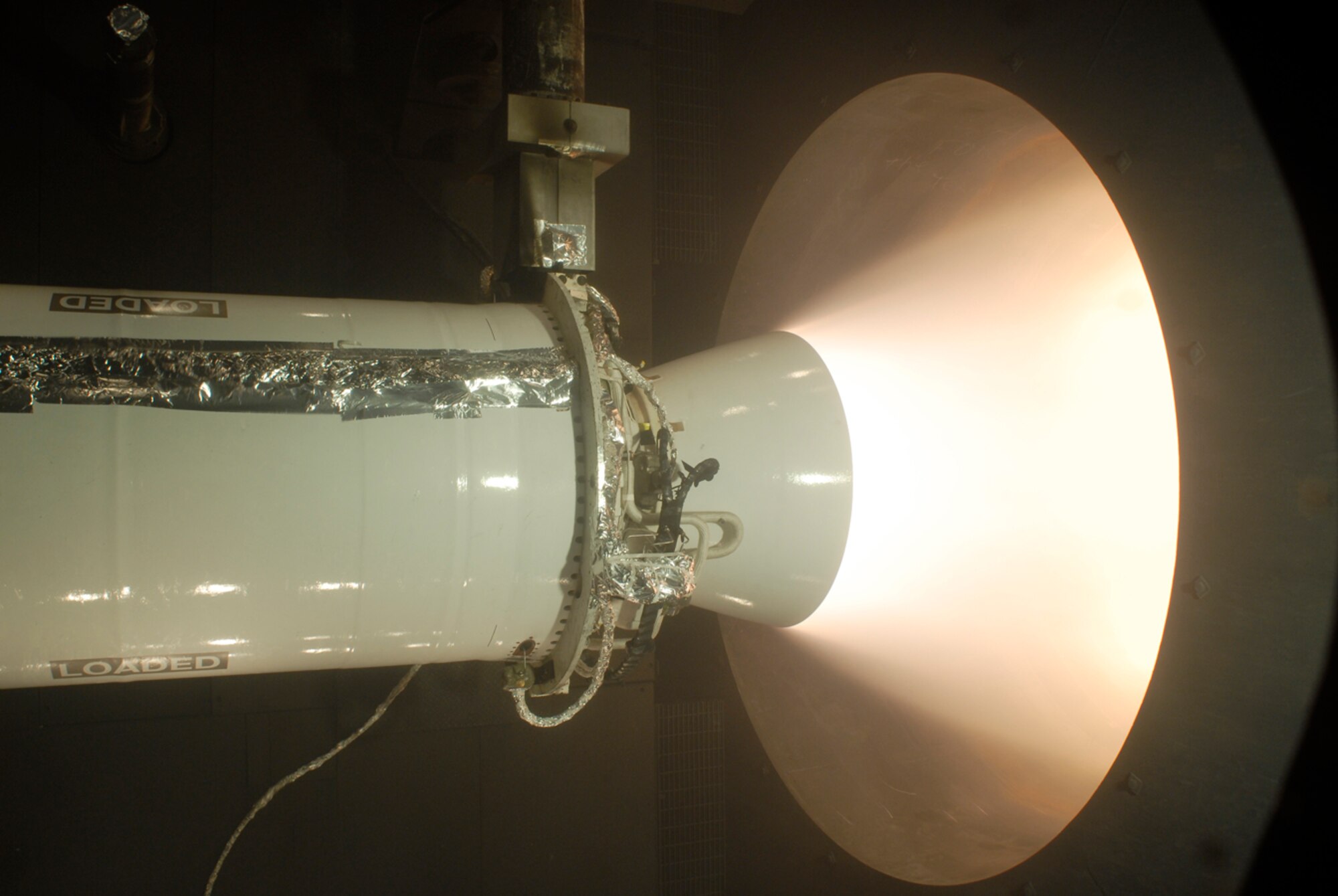White-hot exhaust spews from the nozzle of the Minuteman Stage 2 motor during testing Jan. 18 in the AEDC J-6 Large Rocket Motor Test Facility. (Photo by Rick Goodfriend)