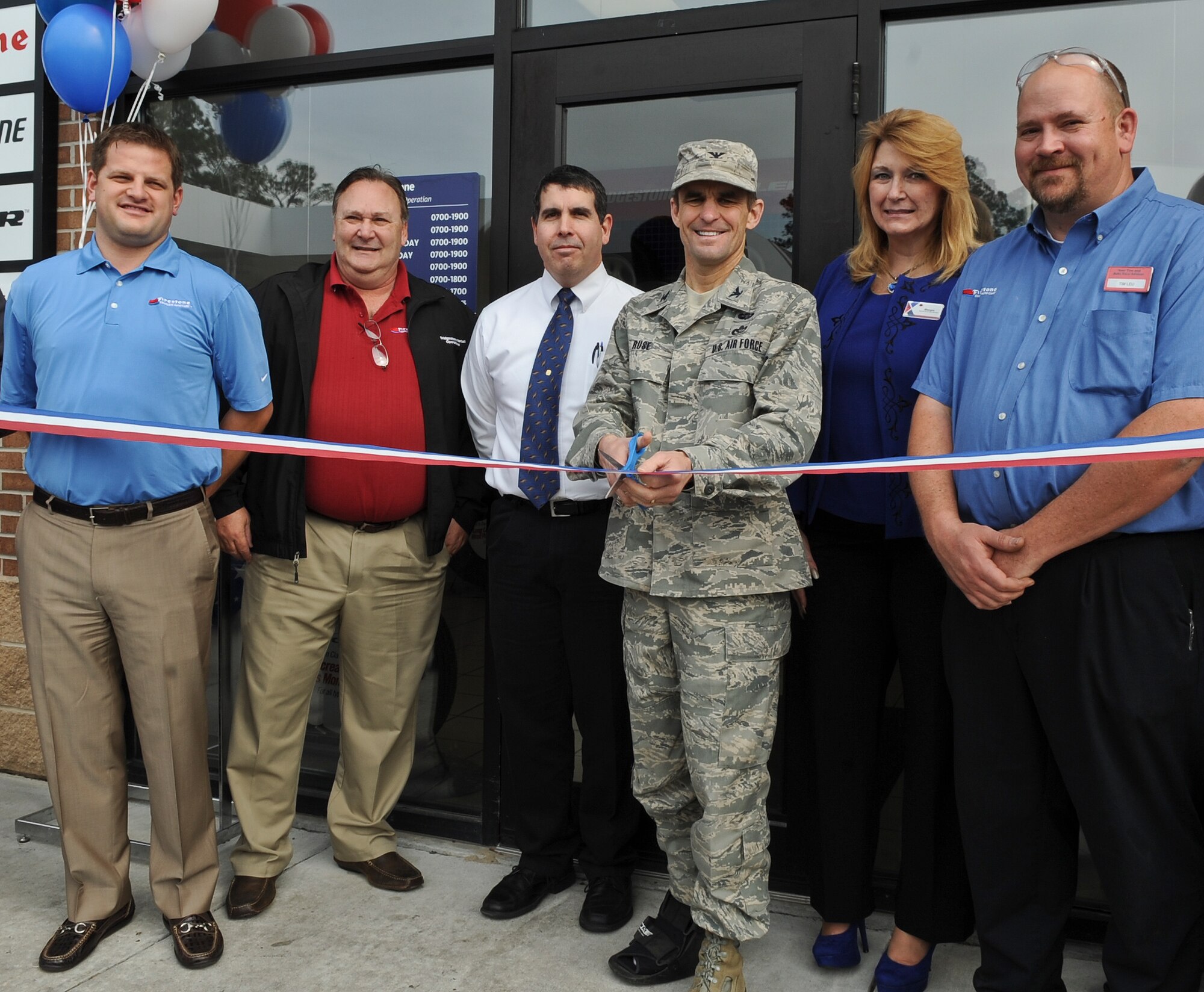 U.S. Air Force Col. Mark Ruse, 23d Mission Support Group commander, cuts the ceremonial ribbon during the grand opening of the Firestone Complete Auto Care Center at Moody Air Force Base, Ga., Feb. 7, 2012. Firestone staff and management threw a “Welcome to the Neighborhood” event to celebrate the services it provides  to Team Moody. (U.S. Air Force photo by Airman 1st Class Olivia Dominique/Released)
