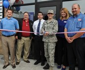 U.S. Air Force Col. Mark Ruse, 23d Mission Support Group commander, cuts the ceremonial ribbon during the grand opening of the Firestone Complete Auto Care Center at Moody Air Force Base, Ga., Feb. 7, 2012. Firestone staff and management threw a “Welcome to the Neighborhood” event to celebrate the services it provides  to Team Moody. (U.S. Air Force photo by Airman 1st Class Olivia Dominique/Released)
