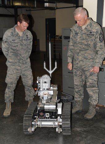 Airman 1st Class Robert Hardy III speaks to Chief Master Sgt. Richard "Andy" Kaiser as he takes an Explosive Ordinance Disposal tour at Joint Base Charleston - Air Base Feb. 7. Kaiser is the Air Mobility Command command chief and is the principal advisor to the commander and his senior staff on matters of health, welfare and morale, professional development and the effective utilization of more than 43,000 active duty and 71,000 Air Force Reserve Command and Air National Guard enlisted personnel assigned to the command. Hardy is a 628th Civil Engineering Squadron EOD apprentice. (U.S. Air Force photo/Airman 1st Class Ashlee Galloway)