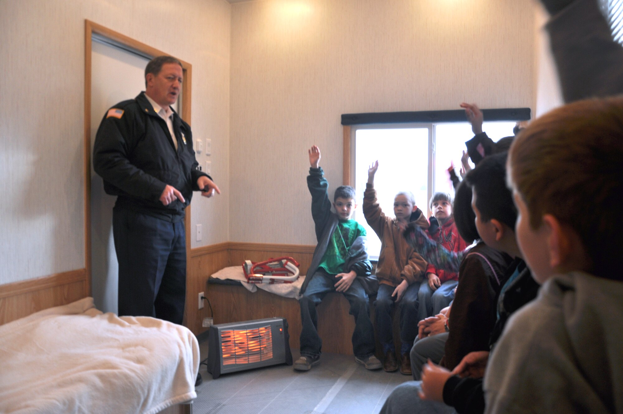 GOODFELLOW AIR FORCE BASE, Texas-- Glenn Haffner, 17th Civil Engineer Squadron assistant fire chief, answers kids’ questions during a visit to Grape Creek Elementary School. They brought a two-bedroom mobile fire safety house to help drive home the importance of fire prevention. (U.S. Air Force photo/Airman 1st Class Jessica Keith) 