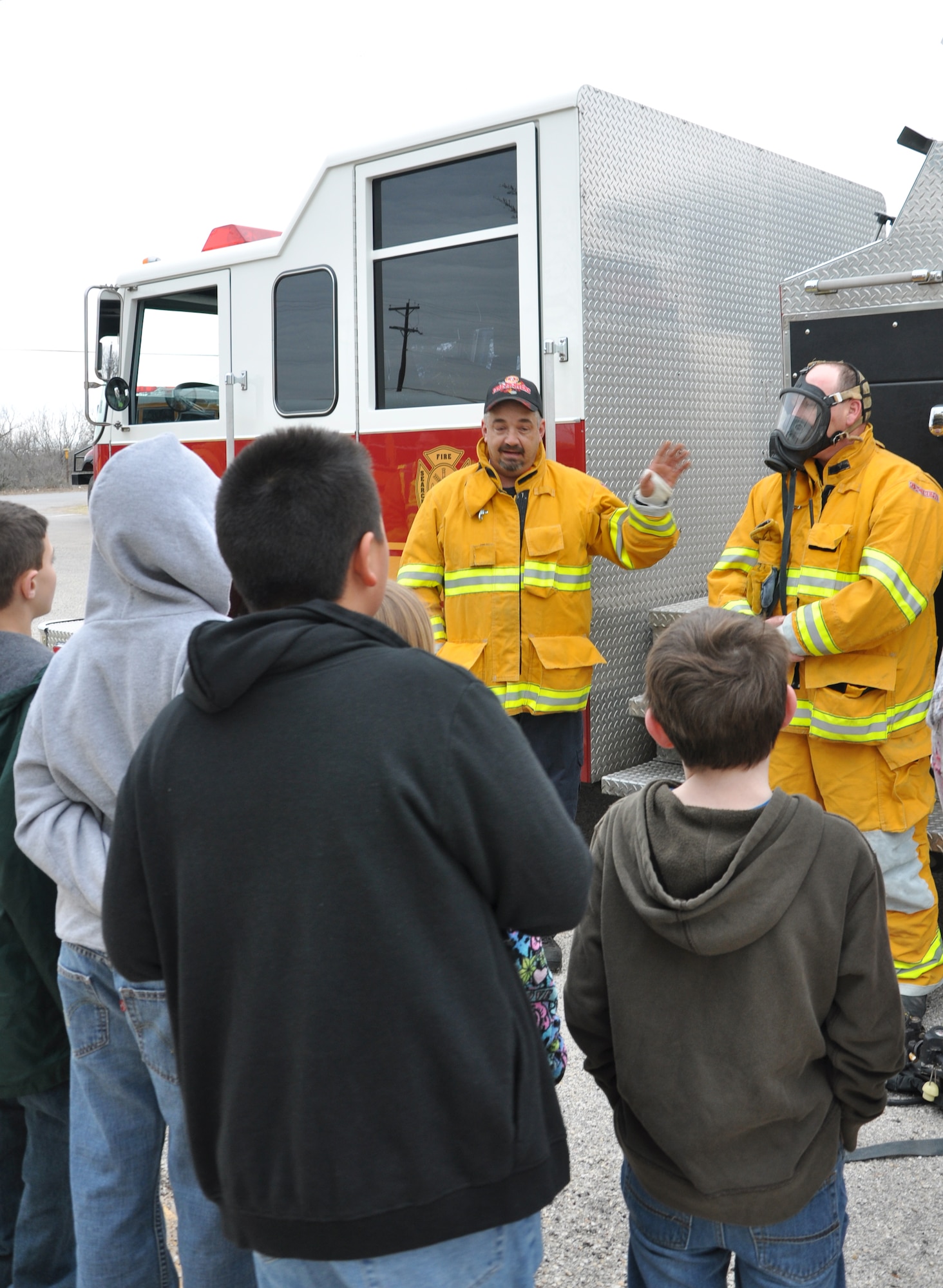 GOODFELLOW AIR FORCE BASE, Texas—Members of the Grape Creek Volunteer Fire Department show kids some of the equipment firefighters use when called out. Members of the 17th Civil Engineer Squadron Fire Emergency Services teamed up with the all volunteer fire department to help educate Grape Creek Elementary School students about the importance of fire safety and prevention. (U.S. Air Force photo/Airman 1st Class Jessica Keith)