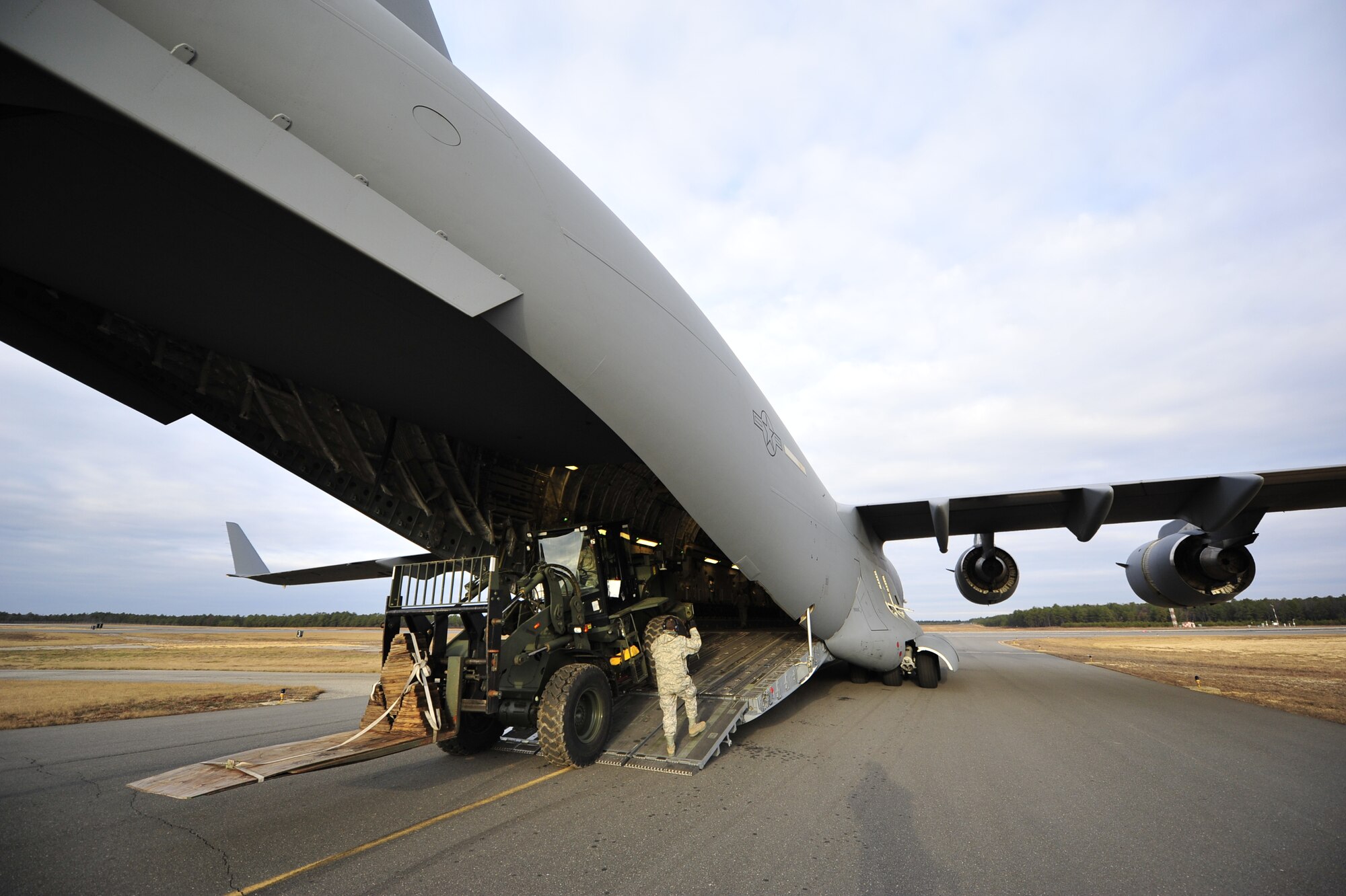 Airmen from the 817th Contingency Response Group, 621st Contingency Response Wing, Joint Base McGuire-Dix-Lakehurst, N.J. load an all-terrain forklift onto a C-17 Globemaster III during a field training exercise at the Lakehurst Naval Air Engineering Station Dec. 8. Airmen in the CRW are expected to deploy worldwide at any time and train constantly in scenarios that recreate the conflicts and humanitarian crises they may be called into to support. (U.S. Air Force photo by Tech. Sgt. Parker Gyokeres/released)