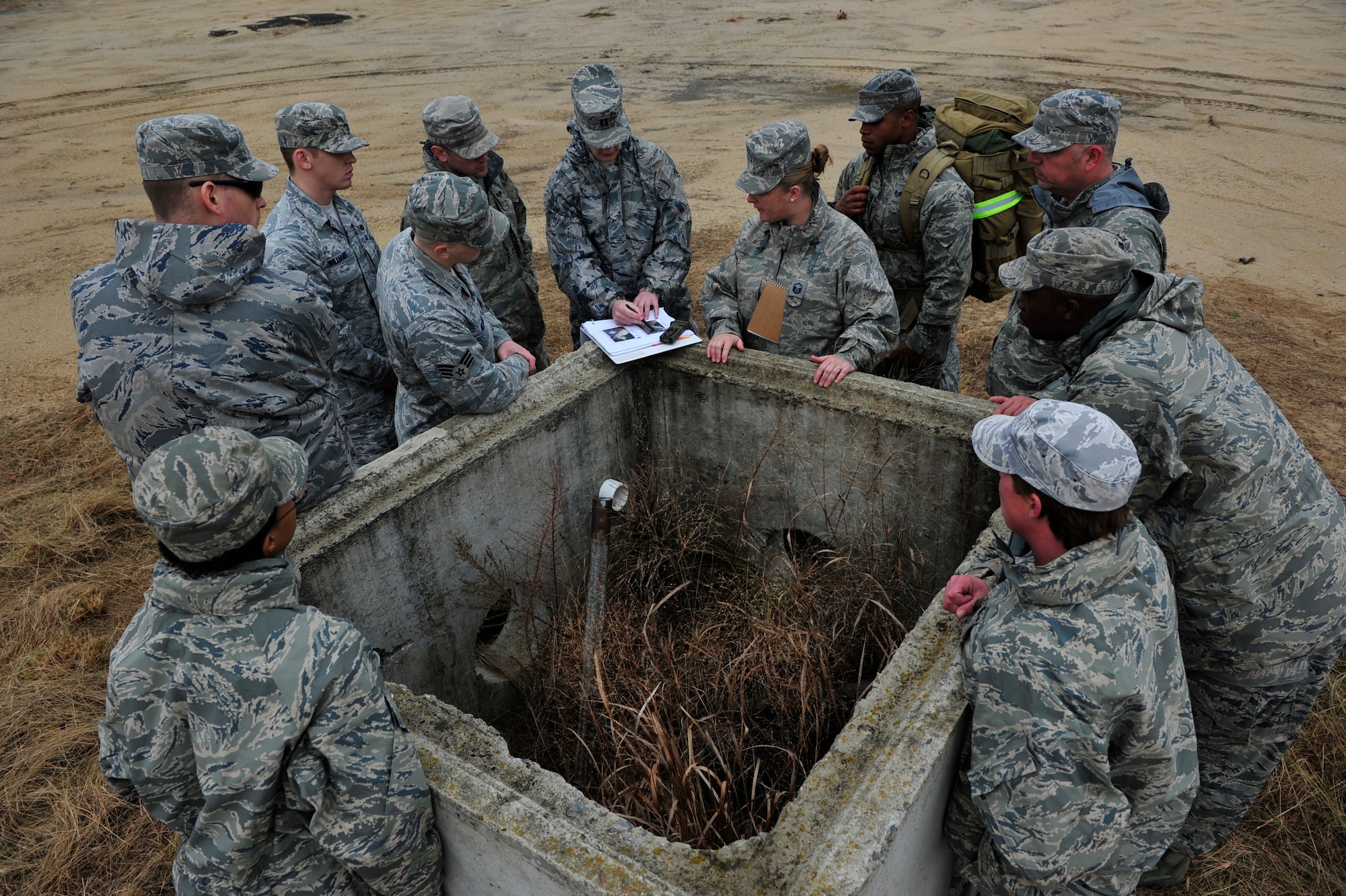 Security forces Airmen from the 621st Contingency Response Wing study an airfield diagram before establishing a perimeter during a field training exercise at the Lakehurst Naval Air Engineering Station Dec. 6. Airmen in the CRW are expected to deploy worldwide at any time and train constantly in scenarios that recreate the conflicts and humanitarian crises they may be called into to support. (U.S. Air Force photo by Tech. Sgt. Parker Gyokeres/released)
