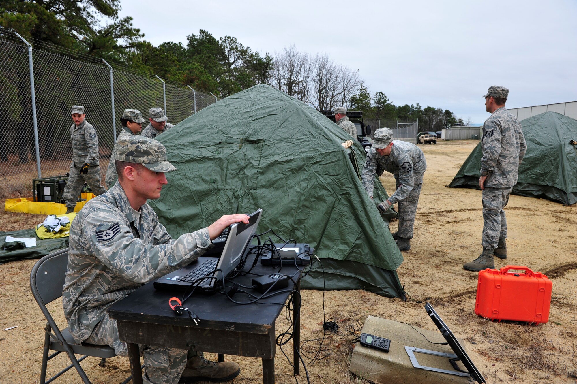 Mobility Airmen from the 817th Contingency Response Group, 621st Contingency Response Wing, Joint Base McGuire-Dix-Lakehurst, N.J. set up tents for a deployed Airfield assessment and aerial port operation during a field training exercise at the Lakehurst Naval Air Engineering Station Dec. 6. Airmen in the CRW are expected to deploy worldwide at any time and train constantly in scenarios that recreate the conflicts and humanitarian crises they may be called into to support. (U.S. Air Force photo by Tech. Sgt. Parker Gyokeres/released)