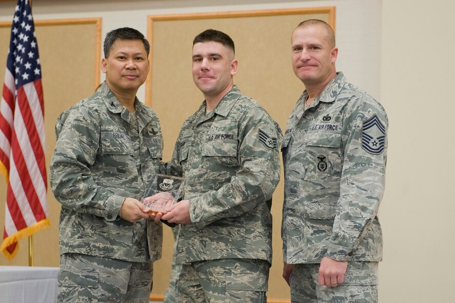 Staff Sgt. Richard Frank, 341st Medical Operations Squadron, center, was named the 341st Missile Wing's Airman of the Quarter for the fourth quarter of 2011.  Shown presenting the award are Col. Heraldo Brual, 341st Missile Wing commander, and Chief Master Sgt. Timothy McLaughlin, 341st Security Forces Group security forces manager.   The presentation was made at the Wing Quarterly Awards breakfast held Jan. 24 at the Community Activities Center on Malmstrom AFB.  (U.S. Air Force photo/ Beau Wade)
