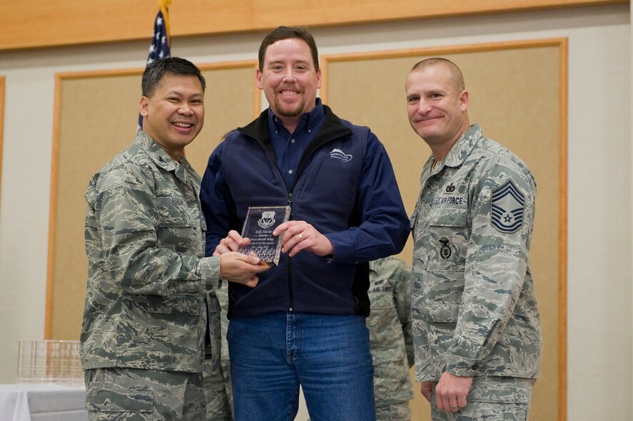 Kelly Fletcher, 341st Civil Engineer Squadron, center, was named the 341st Missile Wing's Category II Civilian of the Quarter for the fourth quarter of 2011.  Shown presenting the award are Col. Heraldo Brual, 341st Missile Wing commander, and Chief Master Sgt. Timothy McLaughlin, 341st Security Forces Group security forces manager.   The presentation was made at the Wing Quarterly Awards breakfast held Jan. 24 at the Community Activities Center on Malmstrom AFB.  (U.S. Air Force photo/ Beau Wade)