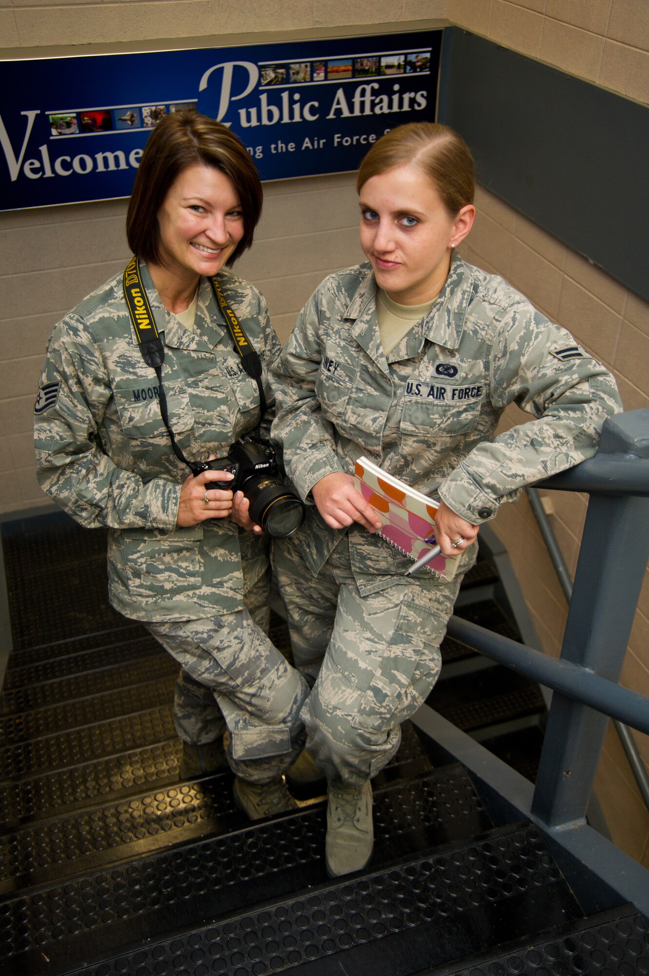 Staff Sgt. Kimberly Moore and Airman 1st Class Heather Heiney, 81st Training Wing Public Affairs, pose for a photo at Wall Studio, Keesler Air Force Base, Miss., Feb. 7, 2012.  Moore took top honors in the Air Education and Training Command’s 2011 Media Contest news photo category.  Heiney  is AETC’s print journalist of the year and also won first place in the commentary category.  (U.S. Air Force photo by Adam Bond)