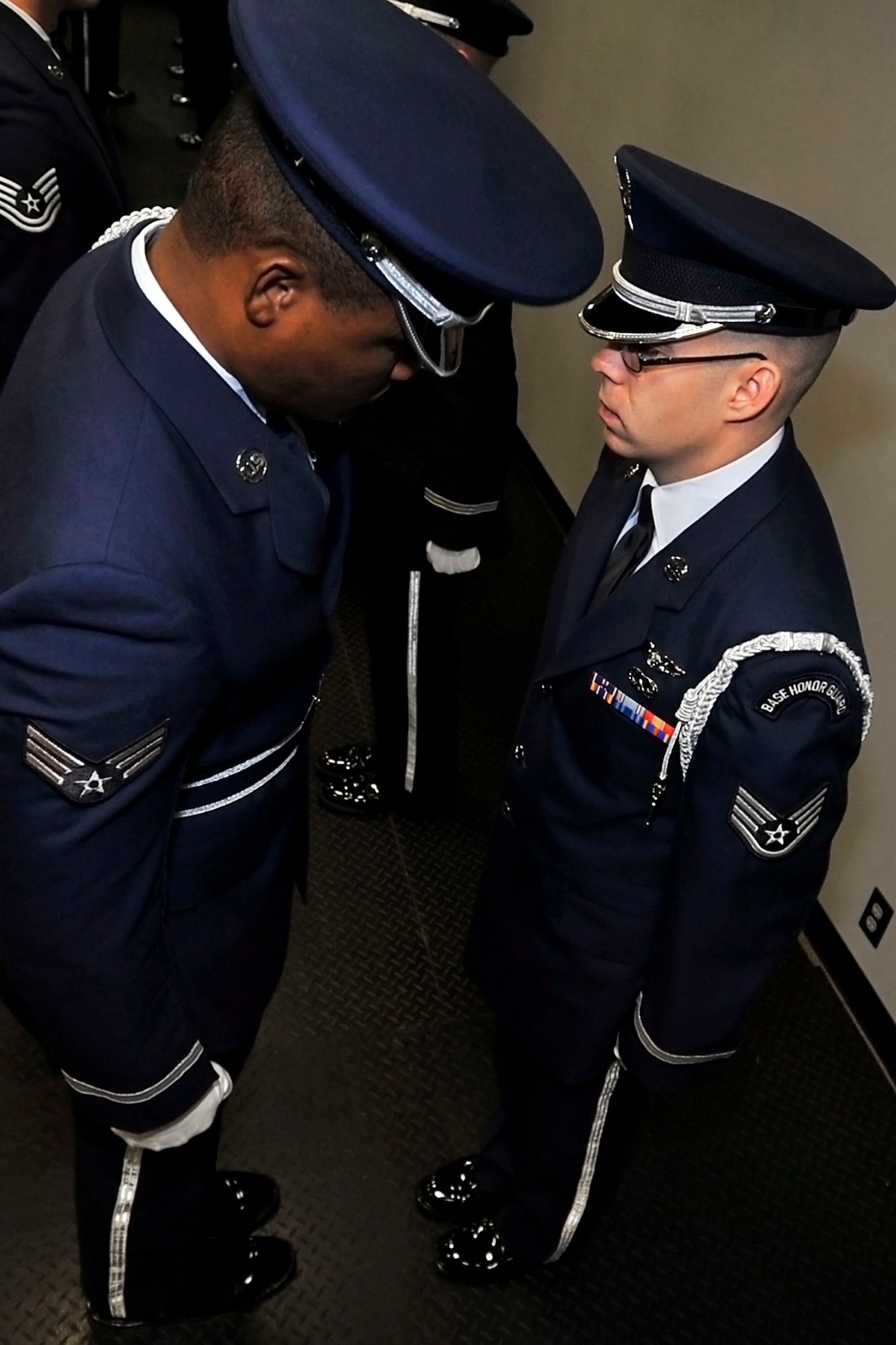 Senior Airman Lesley Toussaint (left), 88th Aerial Port Squadron, looks for uniform violoations during an open-ranks inspection. Toussaint, a reservist, is serving as trainer for the 87th Air Base Wing's active-duty honor guard. (U.S. Air Force photo by Shawn J. Jones)