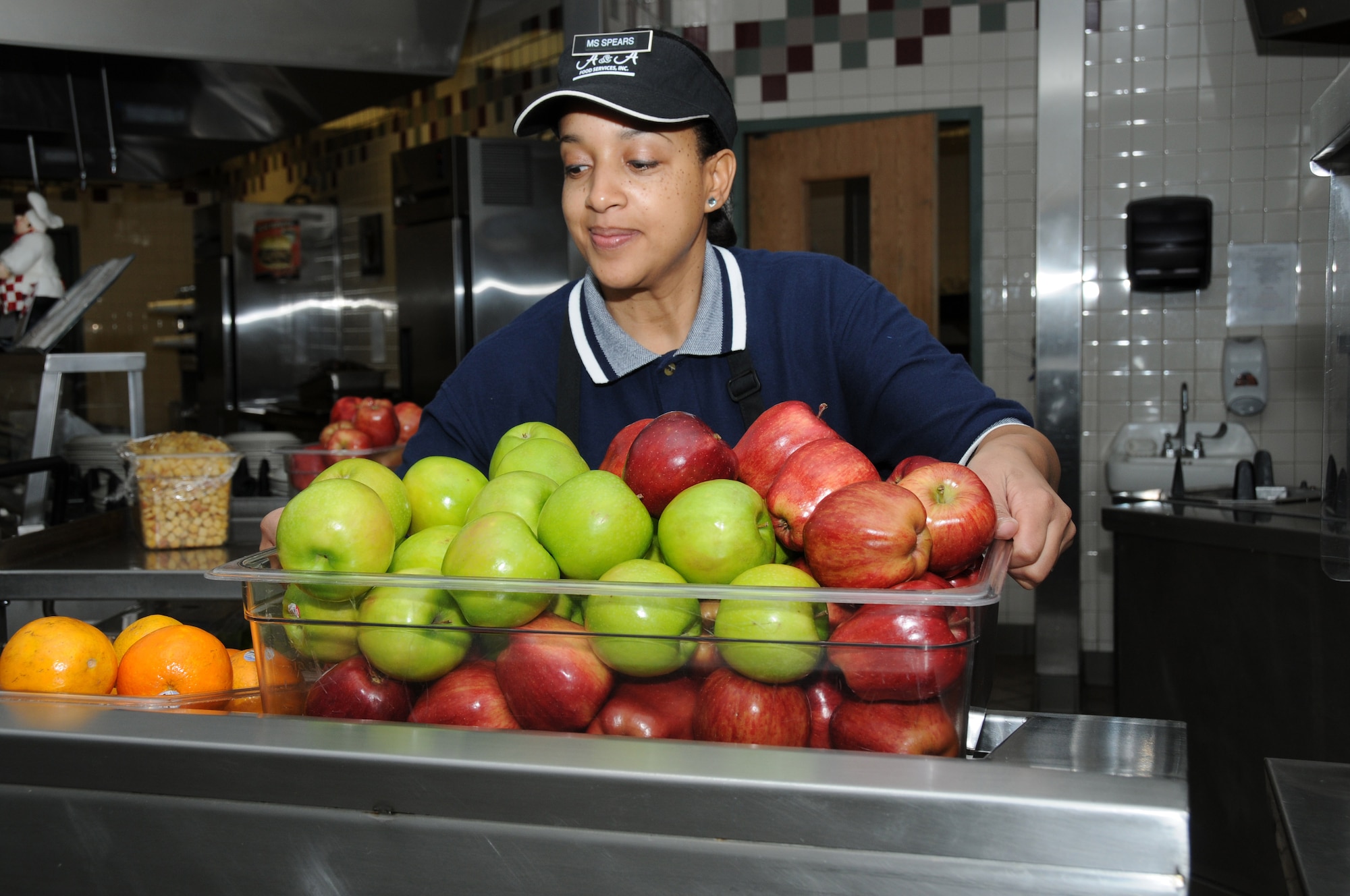 Natasha Spears, 81st Force Support Squadron salad preparer, sets fruit out on the salad bar at the Azalea Dining Facility, Keesler Air Force Base, Miss., Feb. 6, 2012.  Keesler is this year’s Air Education and Training Command nominee for the John L. Hennessy Award as the top food service operation in the Air Force in the multiple facility category.  (U.S. Air Force photo by Kemberly Groue)