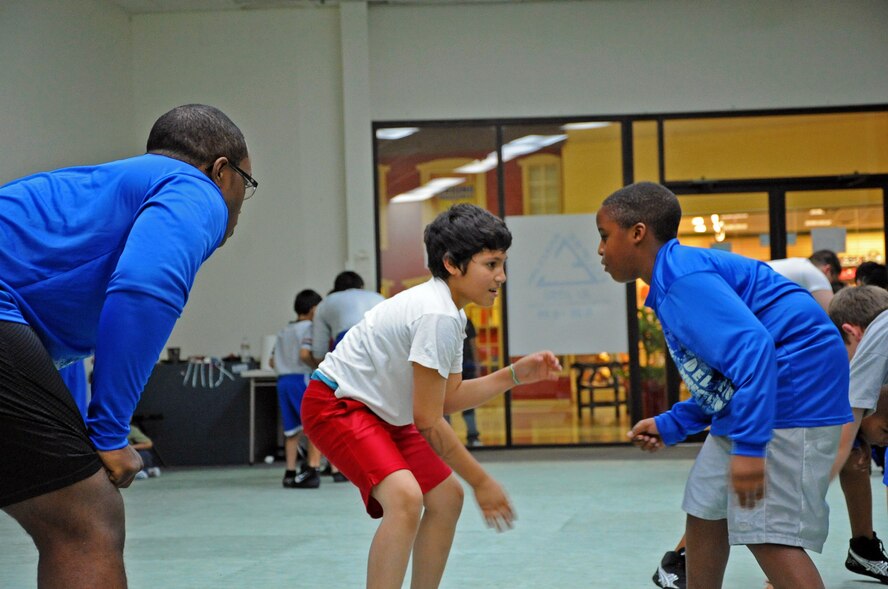 LAUGHLIN AIR FORCE BASE, Texas – 2nd Lt. Randall Mitchner, Del Rio Thunder coach, watches as two of his students practice arm defense moves during a practice at the Eclipse Brazilian Jiu Jitsu gym in Del Rio, Texas, Feb. 2. The Del Rio Thunder wrestling team was recently created by Laughlin Airmen in late November. (U.S. Air Force photo/Senior Airman Scott Saldukas) 