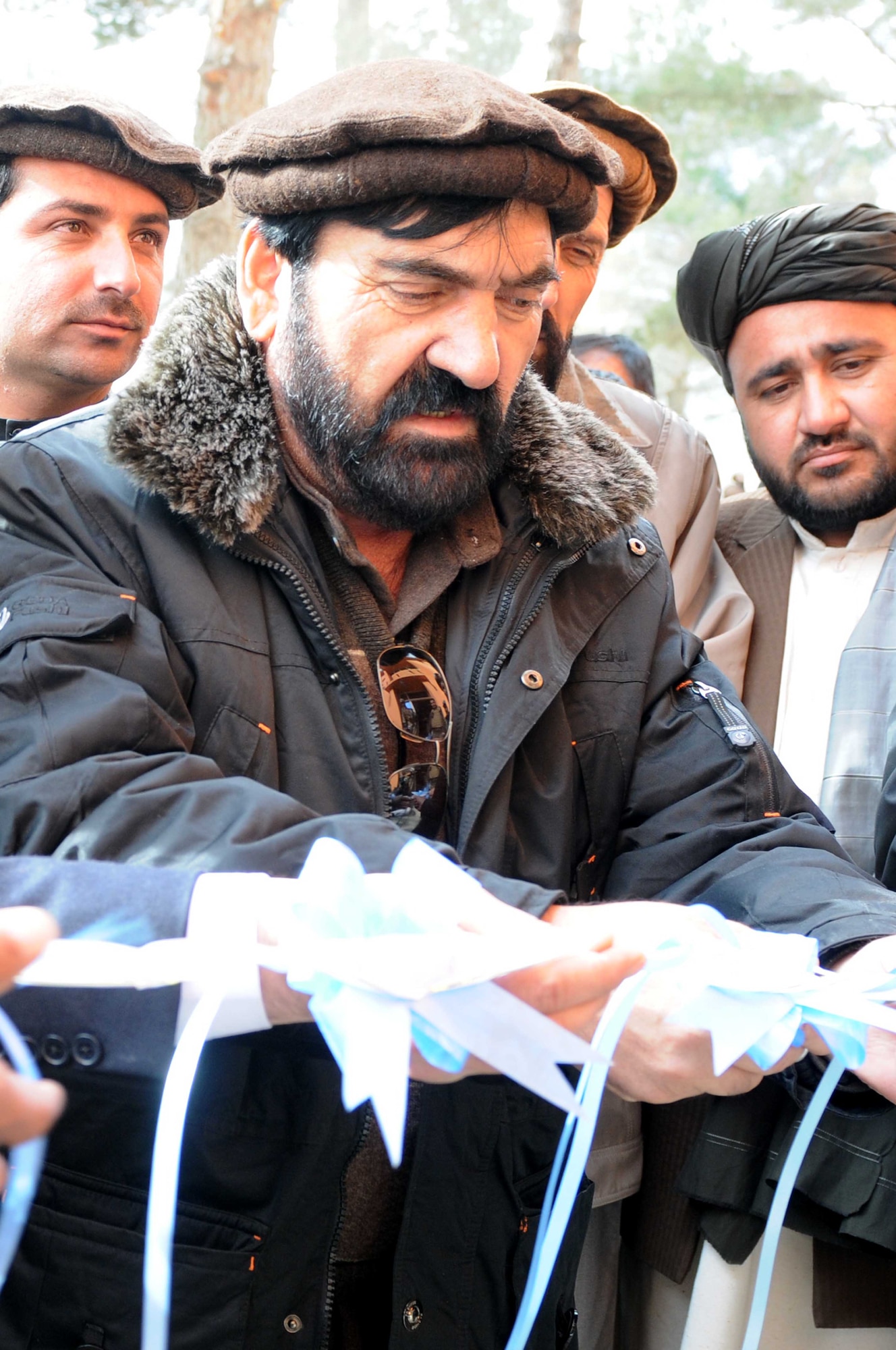 PAKTYA PROVINCE, Afghanistan— Abdul Rahman Mangal, Paktya Province deputy governor, cuts a ribbon during a ceremony celebrating the reopening of the Chamkani District Center in Paktya Province, Afghanistan, Feb 1. Reconstruction efforts following an attack in November, the center reopened in three months for government use. (U.S. Air Force photo by 1st Lt Cammie Quinn, Paktya Provincial Reconstruction Team Public Affairs) 