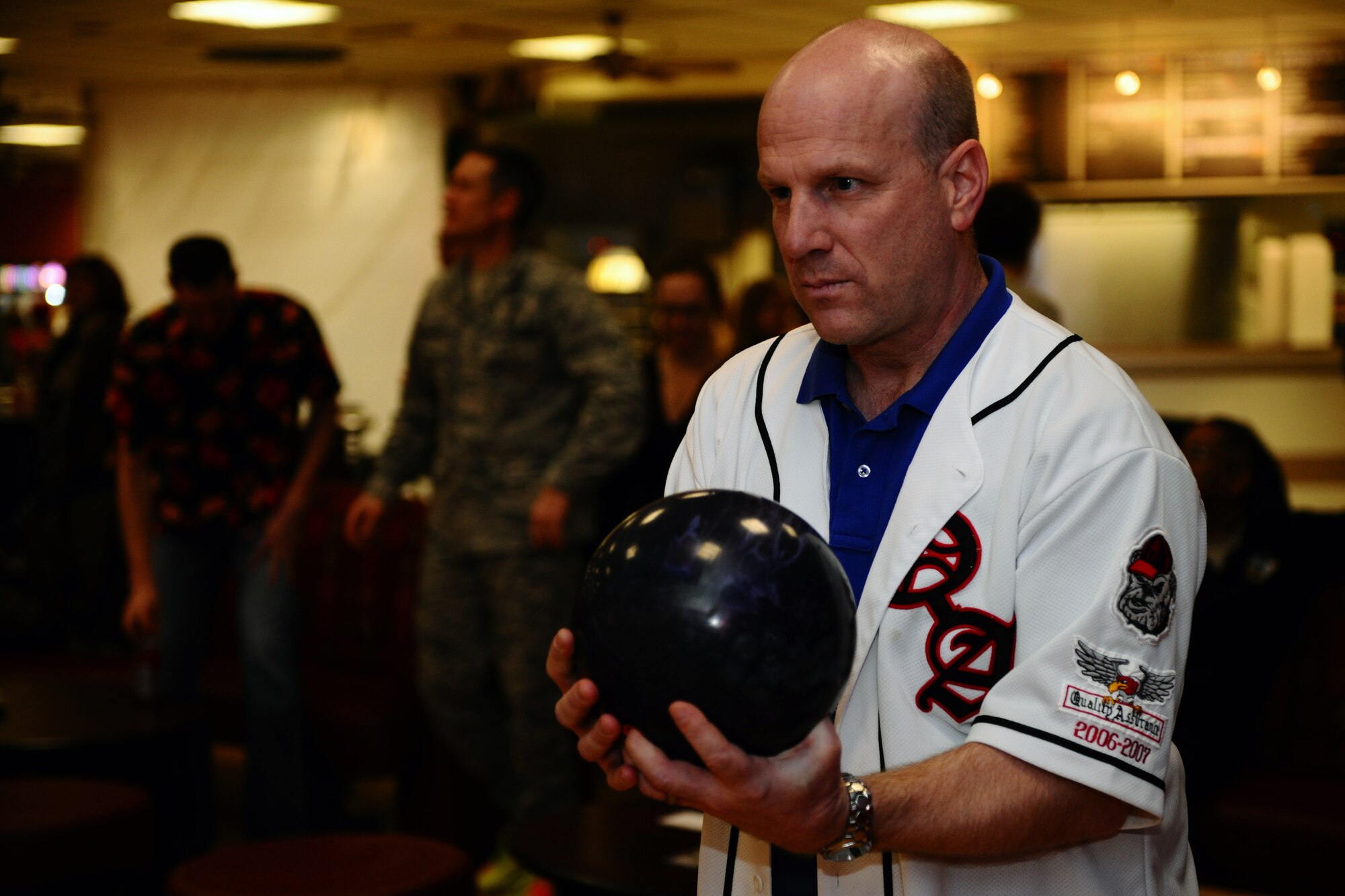 SPANGDAHLEM AIR BASE, Germany – Chief Master Sgt. Ricky Owen, 52nd Equipment Maintenance Squadron chief, lines up on the bowling lane during the “Commanders vs. Chiefs” bowling tournament inside the Eifel Lanes Bowling Center here Feb. 3. The chiefs surmounted the commanders with a total score of 1491 - 1443. The tournament is designed to help build morale and camaraderie between enlisted and commissioned leaders. (U.S. Air Force photo by Airman 1st Class Dillon Davis/Released)