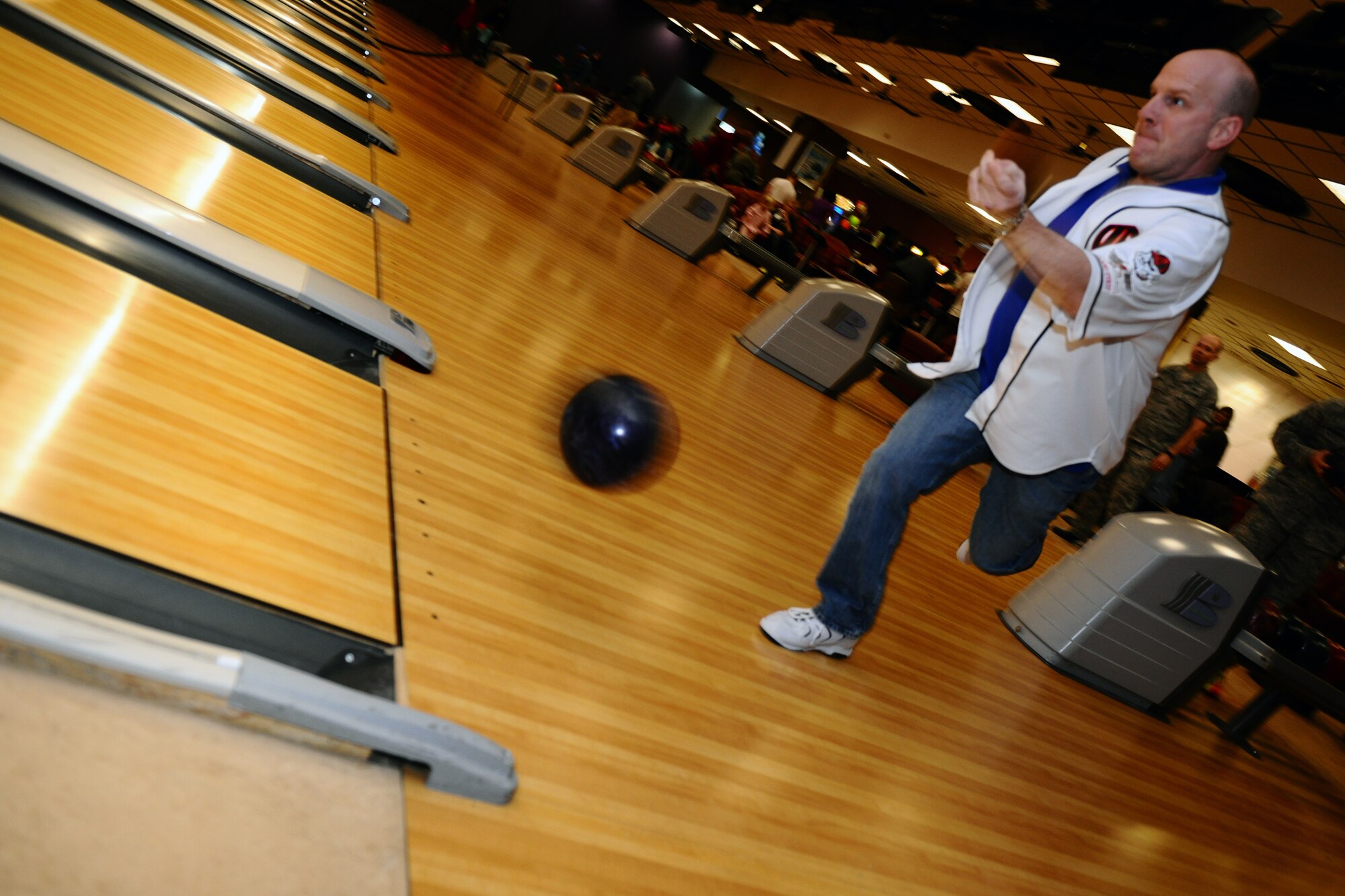 SPANGDAHLEM AIR BASE, Germany – Chief Master Sgt. Ricky Owen, 52nd Equipment Maintenance Squadron chief, throws a bowling ball down a lane during the “Commanders vs. Chiefs” bowling tournament inside the Eifel Lanes Bowling Center here Feb. 3. The chiefs surmounted the commanders with a total score of 1491 - 1443. The tournament allows enlisted and commissioned leaders to compete with one another in a friendly environment outside of work while helping build morale and camaraderie. (U.S. Air Force photo by Airman 1st Class Dillon Davis/Released)