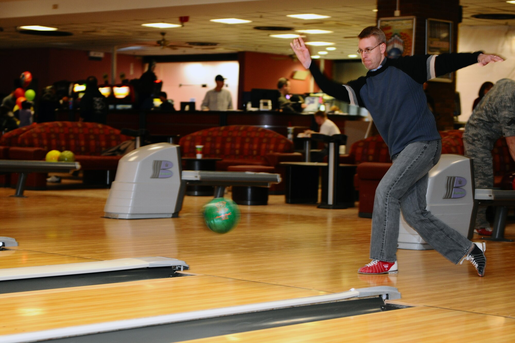 SPANGDAHLEM AIR BASE, Germany – Lt. Col. Greg Buckner, 52nd Maintenance Group vice commander, throws a bowling ball down a lane during the “Commanders vs. Chiefs” bowling tournament inside the Eifel Lanes Bowling Center here Feb. 3. The chiefs surmounted the commanders with a total score of 1491 - 1443. The two teams consisted of six chiefs and six commanders from various base groups and squadrons. (U.S. Air Force photo by Airman 1st Class Dillon Davis/Released)