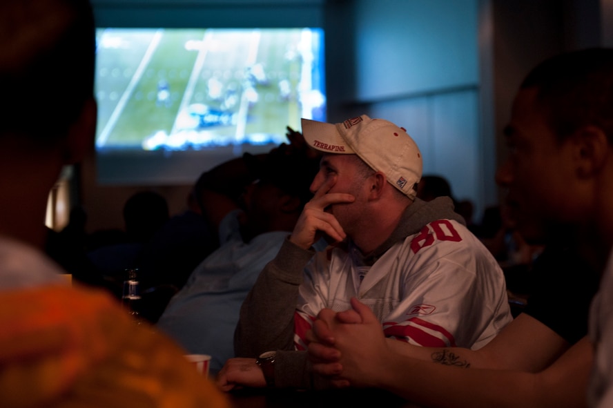 Spectators watch Super Bowl XLVI Feb. 6, 2012, at the Club Complex ballroom at Incirlik Air Base, Turkey. The 39th Force Support Squadron-sponsored event featured a commercial contest that awarded $3,000 in wing funds to the winning unit. The 39th FSS won first and third place, winning $3,000 and $1,000, respectively; the 39th Maintenance Squadron won second, winning $2,000; and the individual category submission was from Nathan Kaw-Uh, who won a $100 voucher toward an Outdoor Recreation Connection trip. (U.S. Air Force photo by Tech. Sgt. Michael B. Keller/Released)