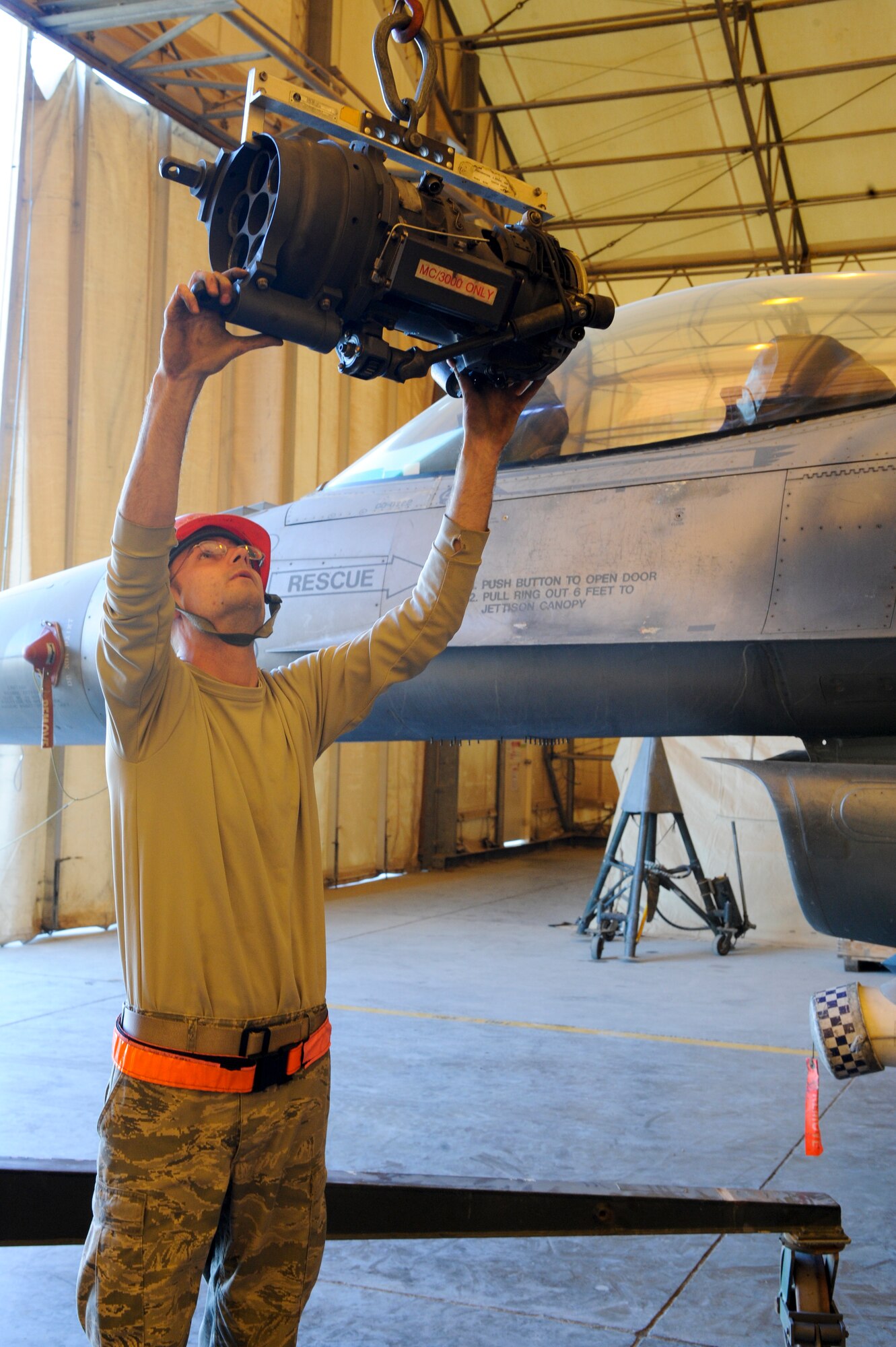 Staff Sgt. Joshua Humphreys, 332nd Expeditionary Aircraft Maintenance Squadron load crew chief, guides a gun rotor away from the aircraft after it was removed from an F-16 Fighter Falcon at an undisclosed location in Southwest Asia, Feb. 5, 2012. Humphreys is deployed from Shaw Air Force Base, S.C., and is a native of Hudson, Mass. (U.S. Air Force photo by Staff Sgt. Joshua J. Garcia/Released)