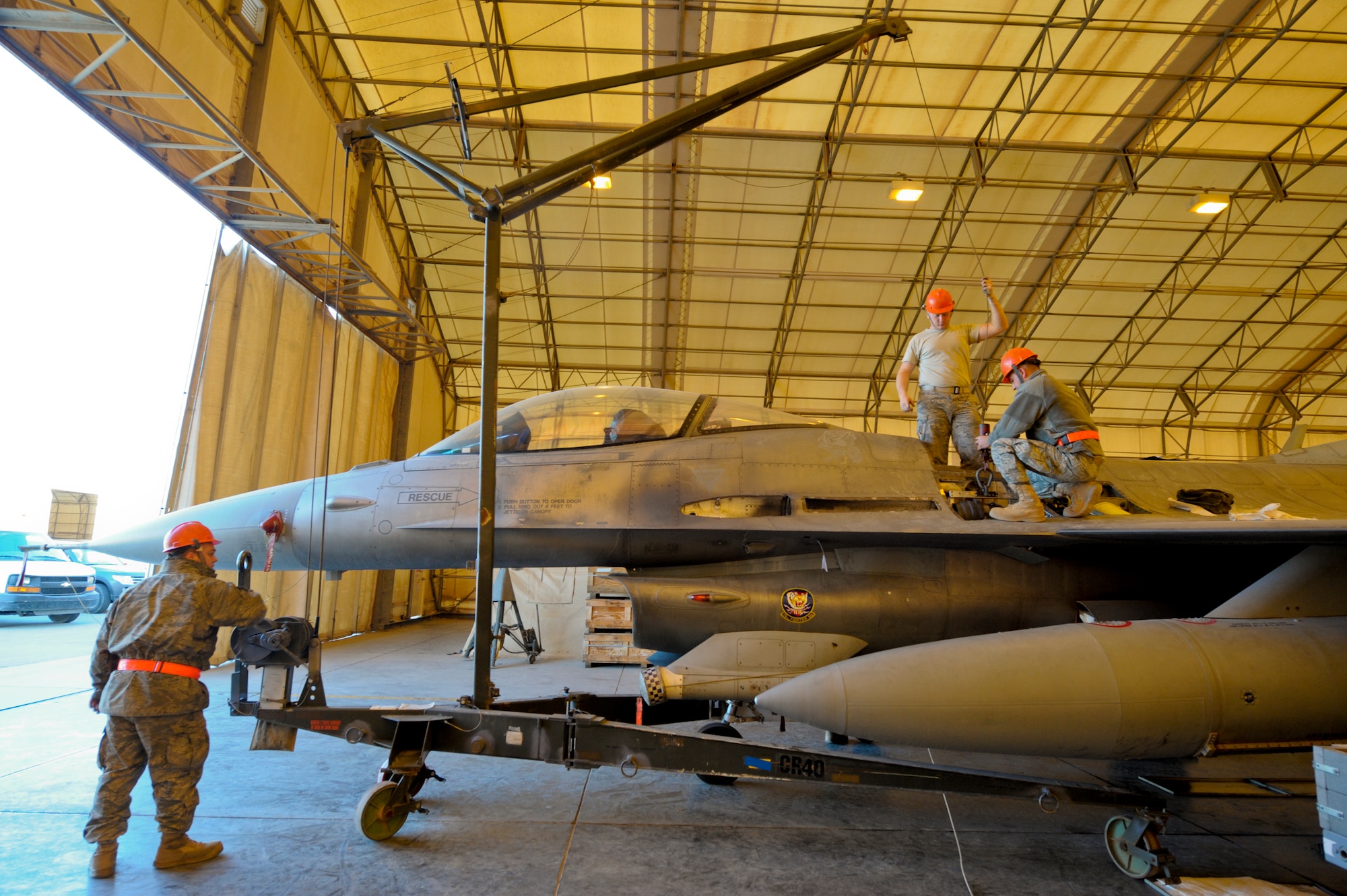 Weapons loaders from the 332nd Expeditionary Aircraft Maintenance Squadron remove an F-16 Fighting Falcon gun rotor at an undisclosed location in Southwest Asia, Feb. 5, 2012. The weapon is completely removed from the aircraft prior to a preventative maintenance inspection. (U.S. Air Force photo by Staff Sgt. Joshua J. Garcia/Released)