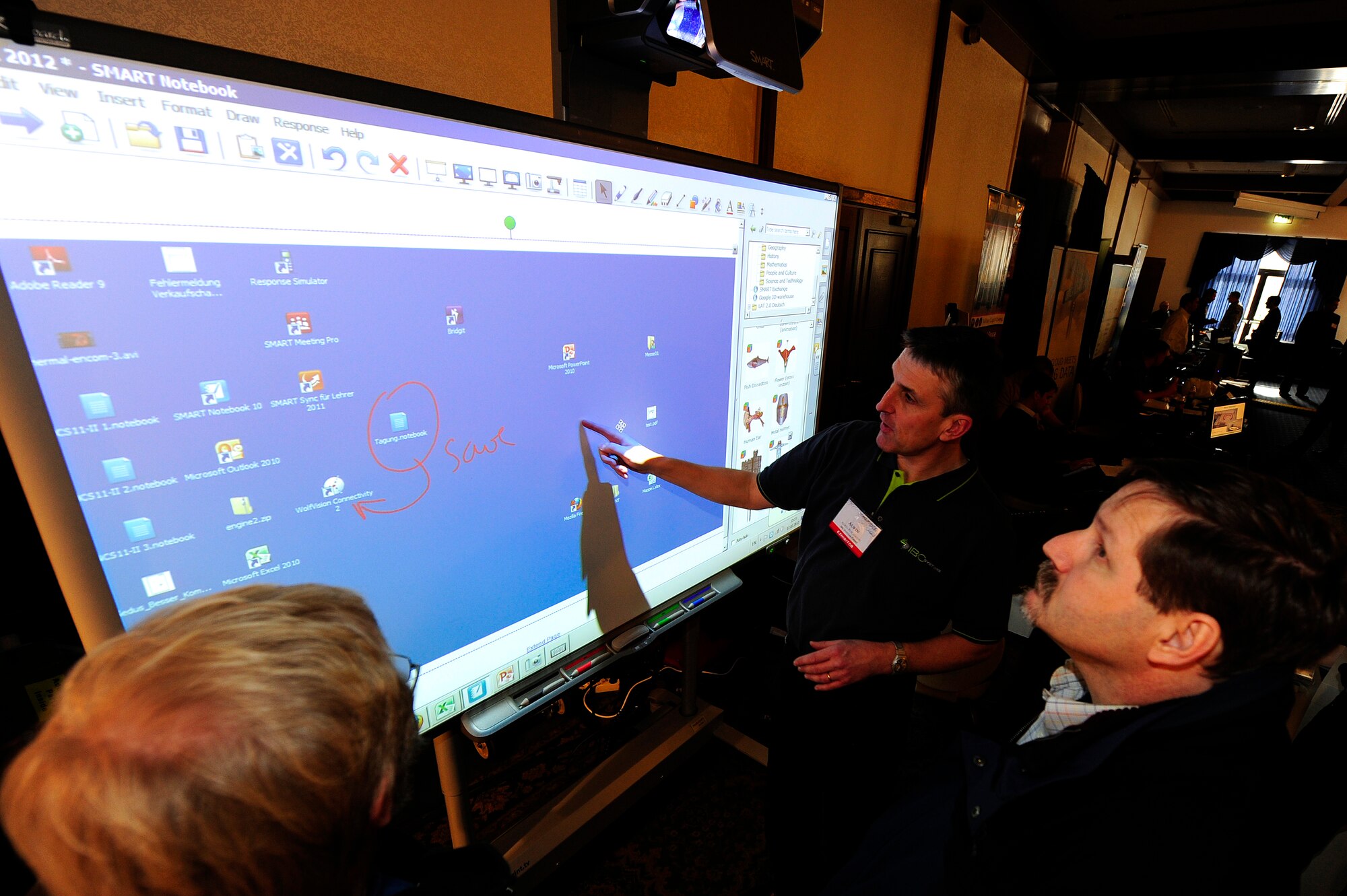 Alwin Puschmann, iBC Systems sales manager, demonstrates the latest in Smart Board interacive display technology, during a technology expo, Ramstein Air Base, Germany, Feb. 7, 2012. The Tech Expo featured multiple federal vendors and provided personnel the opportunity to evaluate the latest emerging and mission related technologies. (U.S. Air Force photo by Senior Airman Stephen J. Otero)