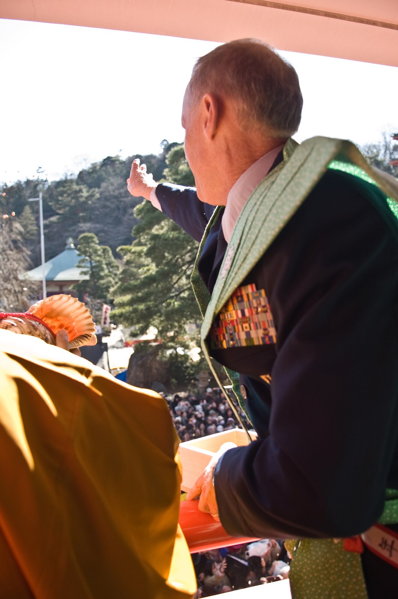 HINO CITY, Japan -- Col. Otto Feather, 374th Airlift Wing commnader, "throws" roasted soy beans during the Bean Throwing Ceremony at the Takahata Fudo Temple in Hino City, Japan, Feb. 3, 2012. The ceremony is an annual event held to celebrate the start of a new year with prospect and good fortune. (U.S. Air Force photo/Airman 1st Class Krystal M. Garrett)