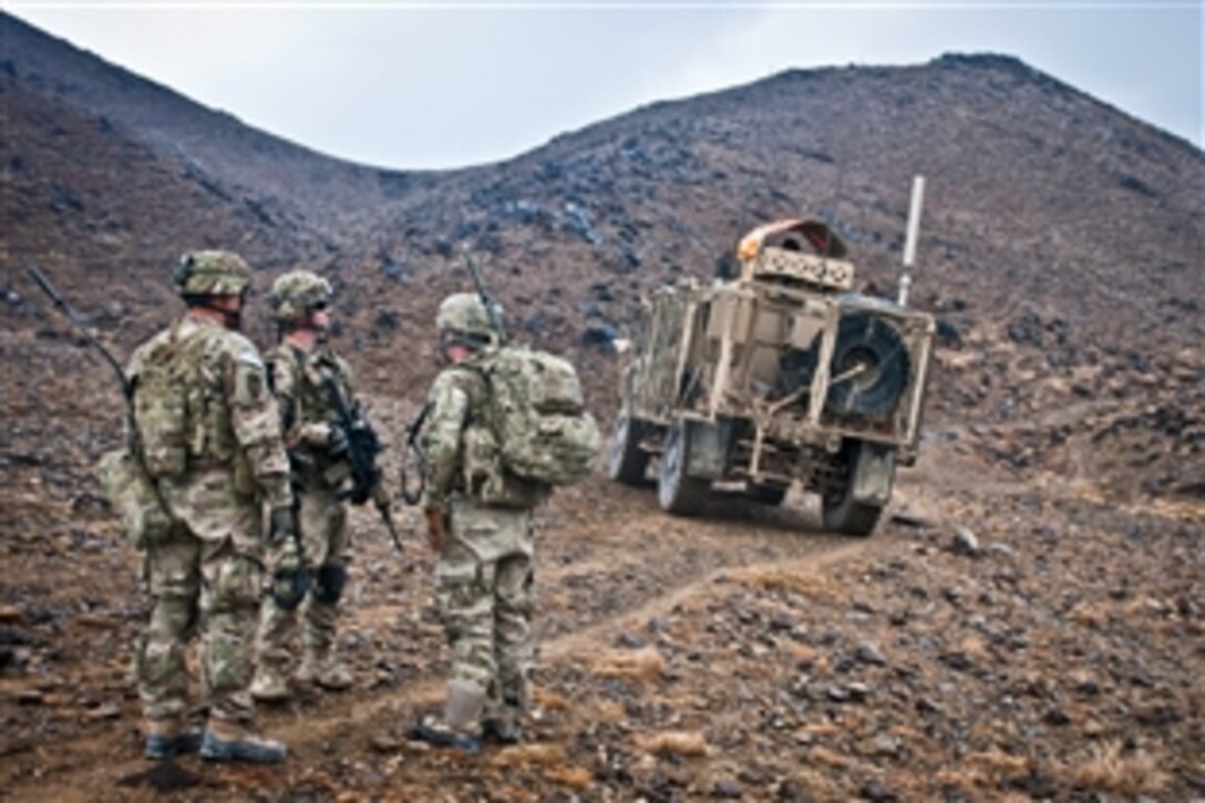 U.S. soldiers prepare to ascend a hillside to Observation Post 11 outside Forward Operating Base Salerno, Afghanistan, Feb. 3, 2012. The unit partnered with Afghan forces to execute a call-for-fire exercise to calibrate large weapons from the top of the the post. The soldiers are assigned to 2nd Battalion, 377th Parachute Field Artillery Regiment.