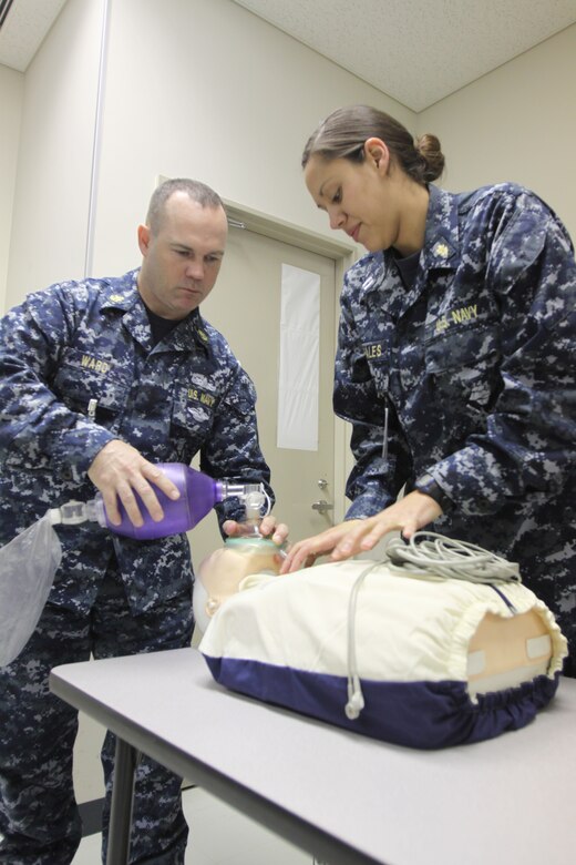 Chief Petty Officer Jim F. Ward, Robert M. Casey Medical and Dental Clinic medical chief, and Navy Lt. Tatiania Morales, Branch Health Clinic general medical officer, use an assisted breathing apparatus on a training dummy during an Advanced Cardiac Life Support course in Building 411 here Feb. 9. The ACLS course deals with several ways to revive or resuscitate an individual should the go into cardiac arrest.