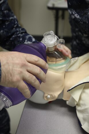 Chief Petty Officer Jim F. Ward, Robert M. Casey Medical and Dental Clinic medical chief, uses a breathing apparatus on a training dummy during the Advanced Cardiac Life Support course at Building 411 here Feb. 9. Participants were tested on a number of scenarios where they had eight minutes to treat the victim.