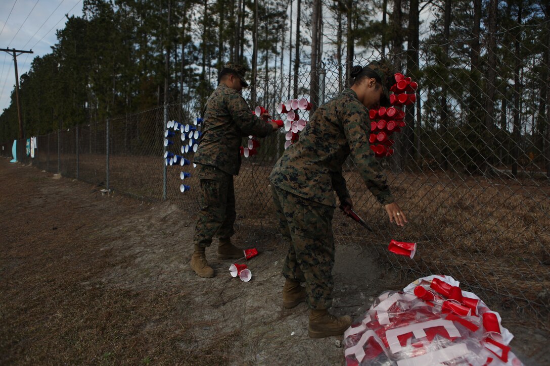 A Marine with Headquarters and Support Battalion removes homecoming signs from fences aboard Marine Corps Base Camp Lejeune, Feb. 9. Base personnel monitor the signs posted to ensure that all the content is in accordance with banner policy.
