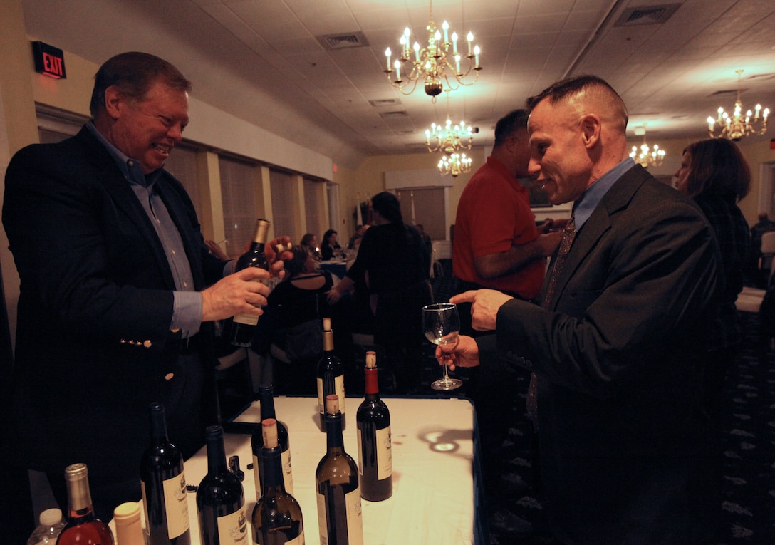 Col. Daniel J. Lecce, the commanding officer of Marine Corps Base Camp Lejeune (right) asks Bo Lindgren, the owner of Edward and Sophie Rollat winery (left) to pour wine into his glass during the Wine Tasting event held at the Paradise Point Officers’ Club aboard MCB Camp Lejeune, recently. Paradise Point Officers’ Club will be hosting their next wine tasting on March 8.