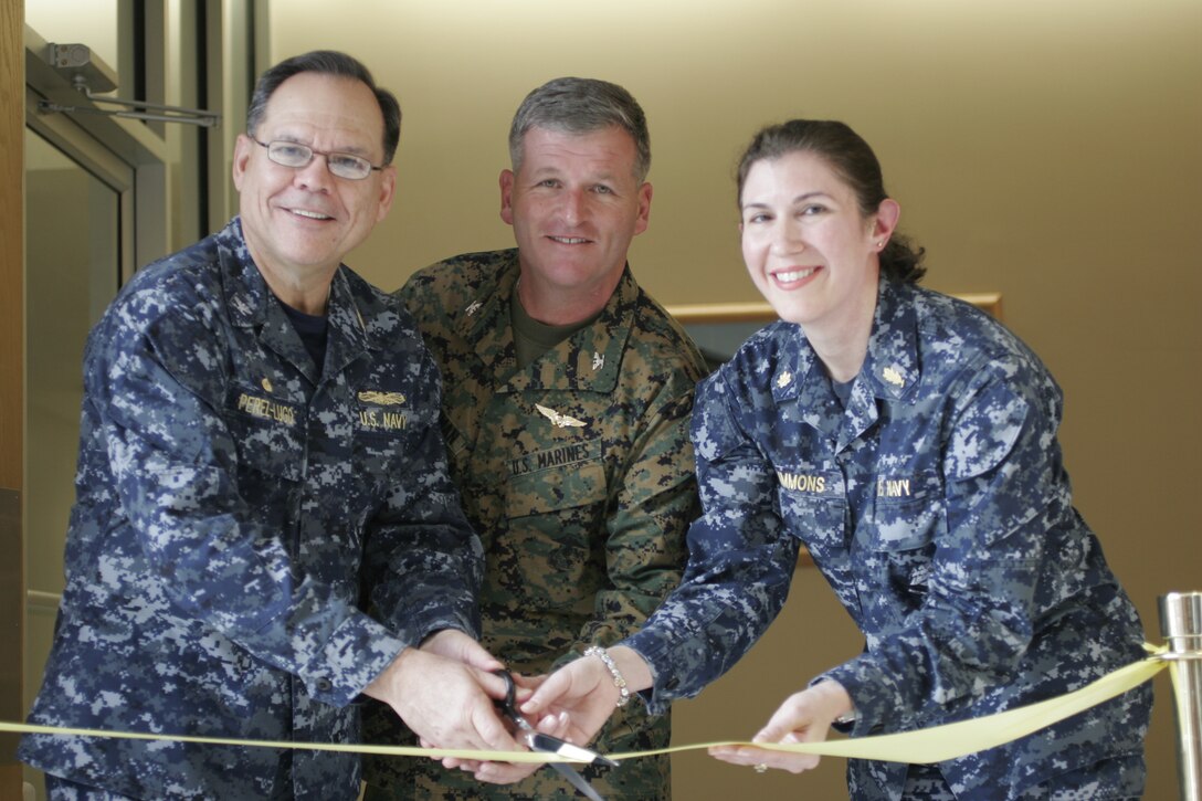 (Left to Right) Navy Capt. Edgardo Perez-Lugo, commanding officer of Naval Health Clinic Cherry Point, Col. Philip J. Zimmerman, commanding officer of Marine Corps Air Station Cherry Point, and Lt. Cmdr. Erin M. Simmons, department head of the mental health clinic at the Naval clinic, conduct a ribbon cutting ceremony Feb. 9 for the clinic’s revamped, relocated mental health clinic. The facility used to be on the first floor of the clinic but moved to the third because of a lack of space. The upstairs location provides a much more suitable environment, said Simmons.