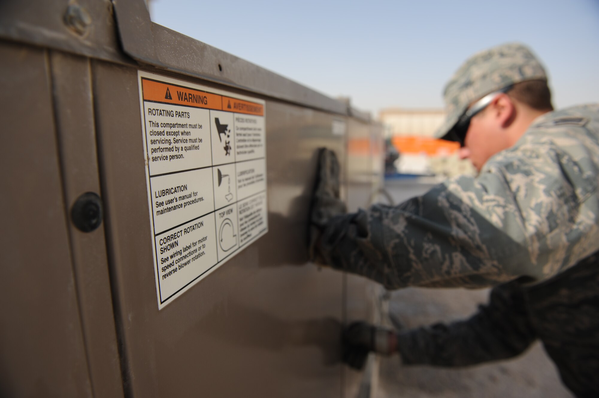 SOUTHWEST ASIA – Airman 1st Class David Yarolimek, 379th Expeditionary Civil Engineer Squadron heating, ventilation, and air conditioning technician and native of St. Augustine, Fla., closes an air conditioning unit panel here Feb. 7, 2012. HVAC technicians are trained in air conditioning unit maintenance, new unit installation, and system repair. (U.S. Air Force photo/Staff Sgt. Nathanael Callon)