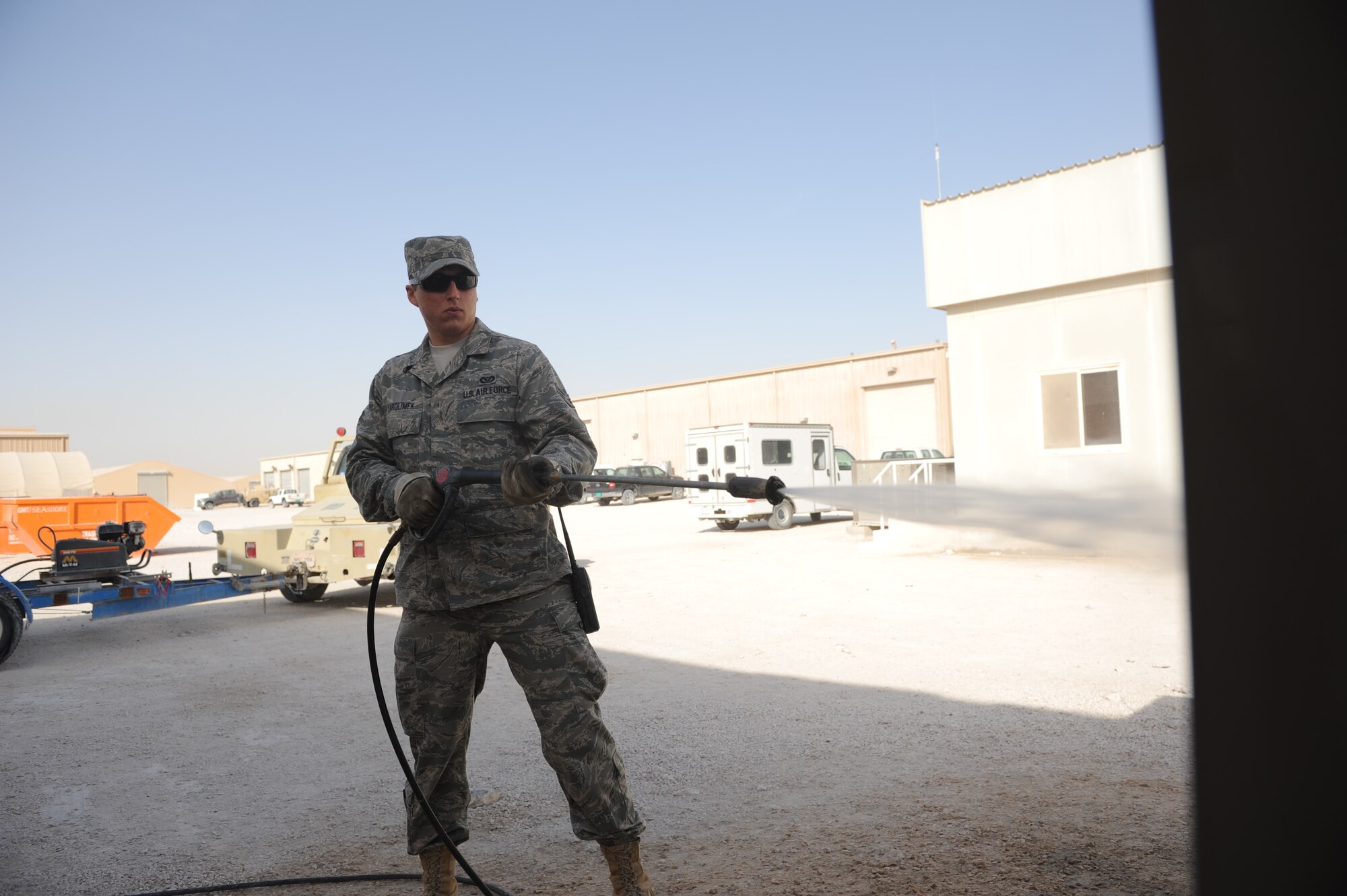 SOUTHWEST ASIA – Airman 1st Class David Yarolimek, 379th Expeditionary Civil Engineer Squadron heating, ventilation, and air conditioning technician and native of St. Augustine, Fla., pressure washes an air conditioner unit here Feb. 7, 2012. The 379th ECES HVAC shop cleans about 120 units every week. (U.S. Air Force photo/Staff Sgt. Nathanael Callon)