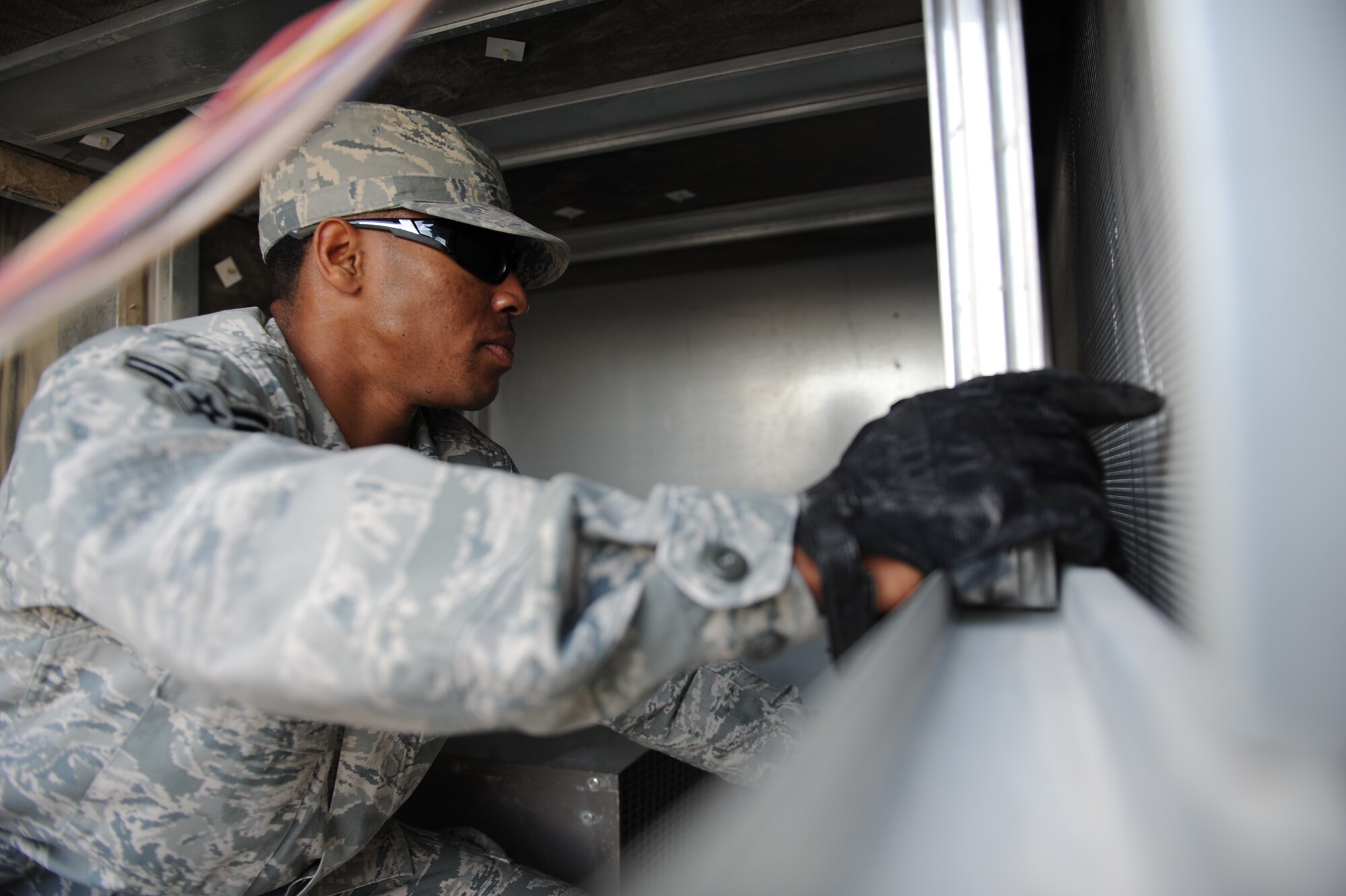 SOUTHWEST ASIA – Airman 1st Class Terence Myers, 379th Expeditionary Civil Engineer Squadron heating, ventilation, and air conditioning technician and native of Danville, Va., removes filters from inside an air conditioning unit here Feb. 7, 2012. The 379th ECES HVAC shop cleans all air conditioning units on base to keep the units functioning properly. (U.S. Air Force photo/Staff Sgt. Nathanael Callon)