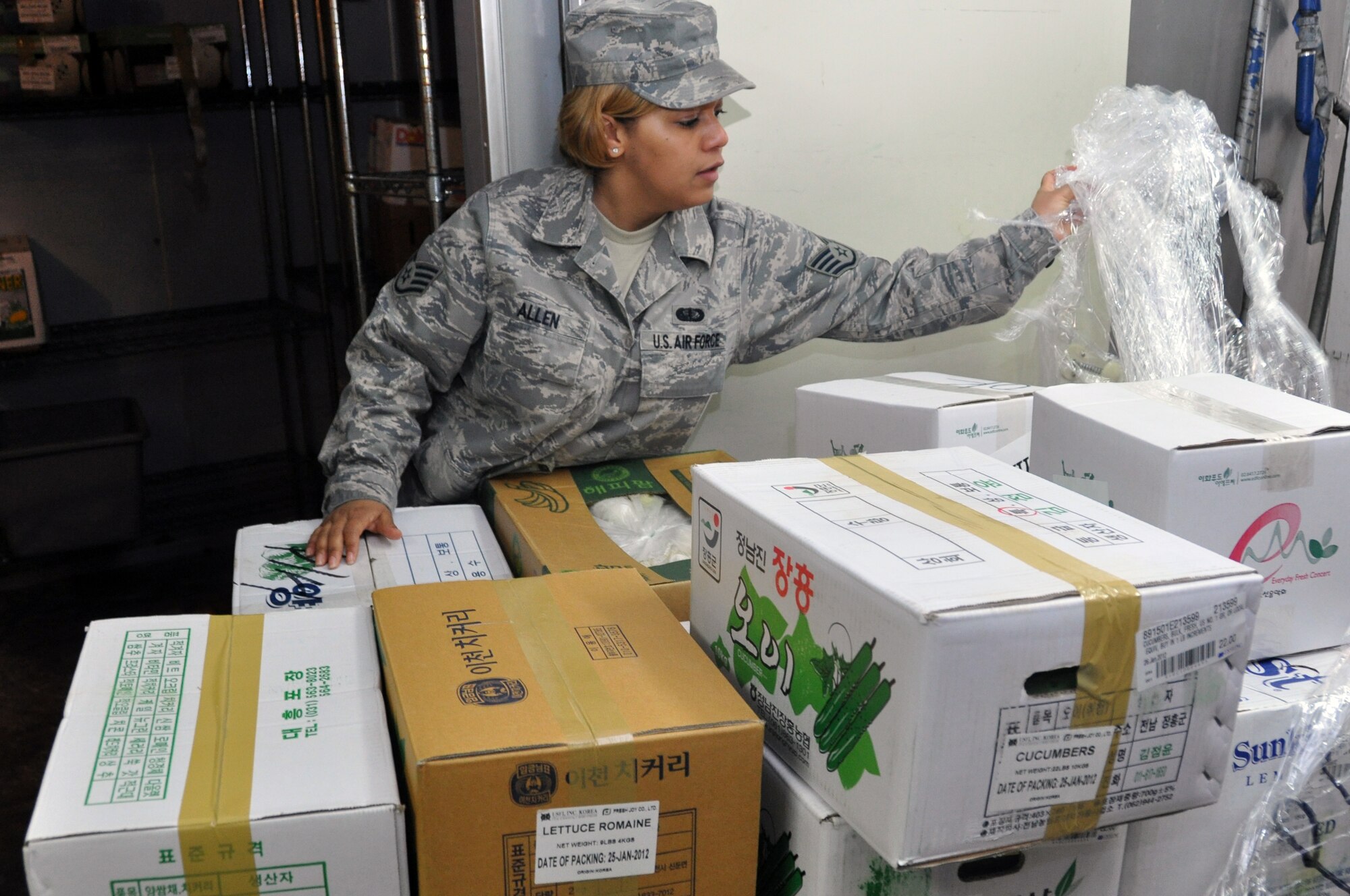 Staff Sgt. Chelby Allen, 51st Force Support Squadron Pacific House stockroom manager, receives a delivery of fresh produce from a local Korean vendor at the Osan Air Base Pacific House Dining Facility, Jan. 28, 2012. The Osan dining facilities serve more than 4,000 pounds of food a day. (U.S. Air Force photo/Airman 1st Class Michael Battles)