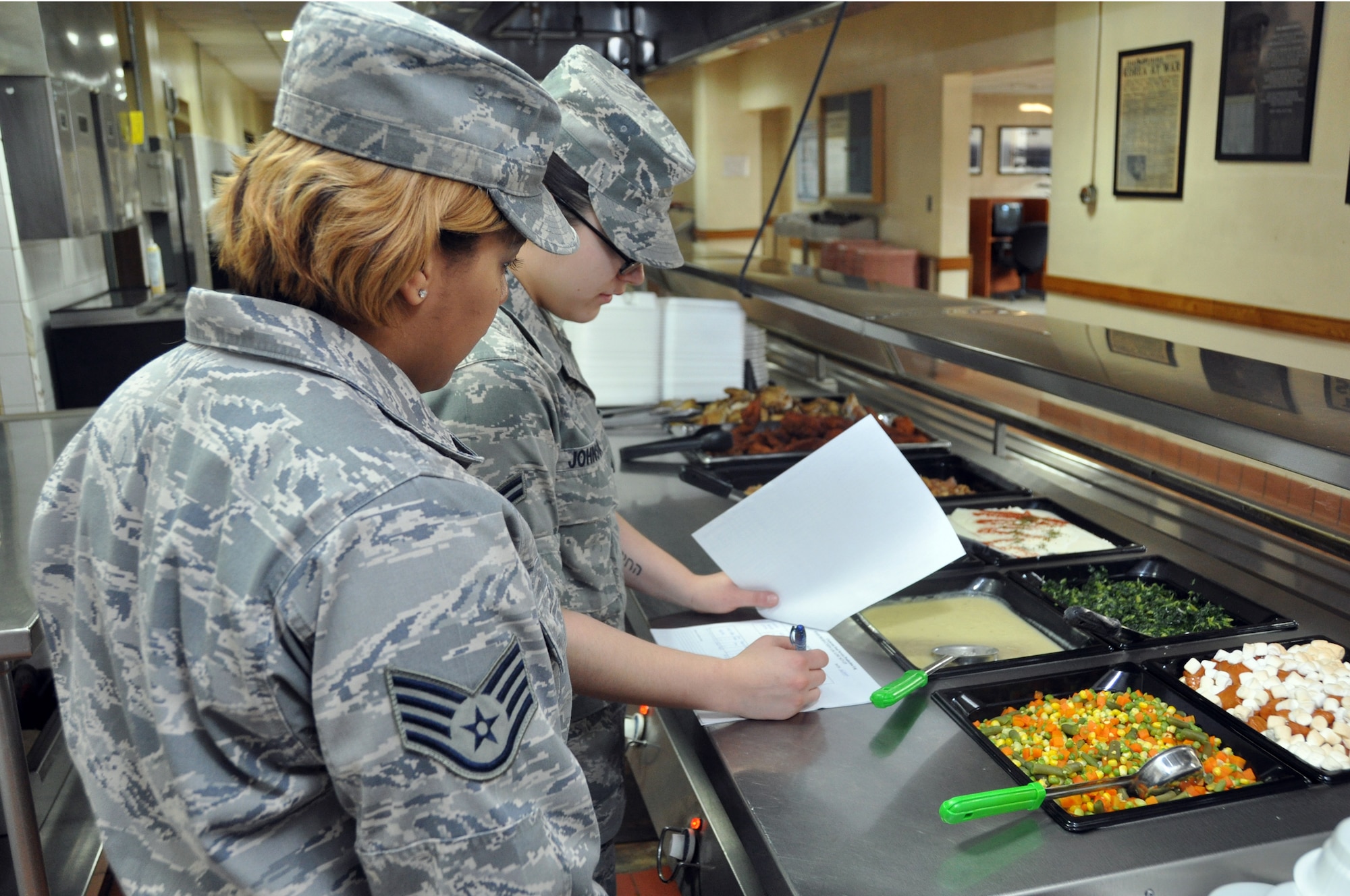 Staff Sgt. Chelby Allen and Airman 1st Class Mariah Johnson, 51st Force Support Squadron, prepare the serving line for lunch at the Osan Air Base Pacific House Dining Facility, Jan. 28, 2012. (U.S. Air Force photo/Airman 1st Class Michael Battles)