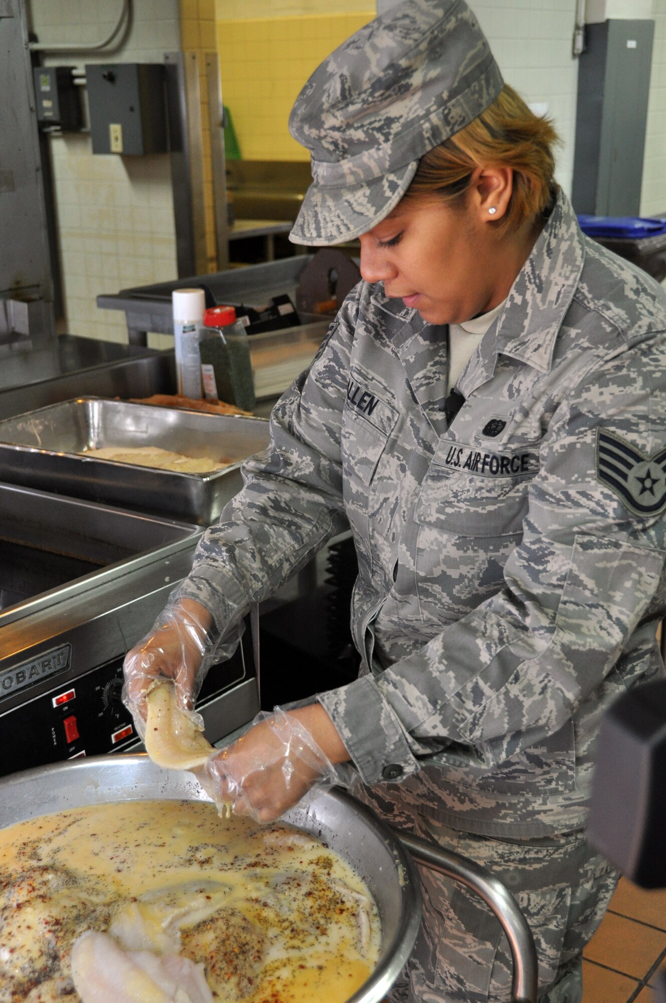 Staff Sgt. Chelby Allen, 51st Force Support Squadron Pacific House stockroom manager, prepares catfish to be served during lunch at the Osan Air Base Pacific House Dining Facility, Jan. 28, 2012.  Dining facility Airmen serve more than 1.3 million meals each year between three dining facilities. (U.S. Air Force photo/Airman 1st Class Michael Battles)