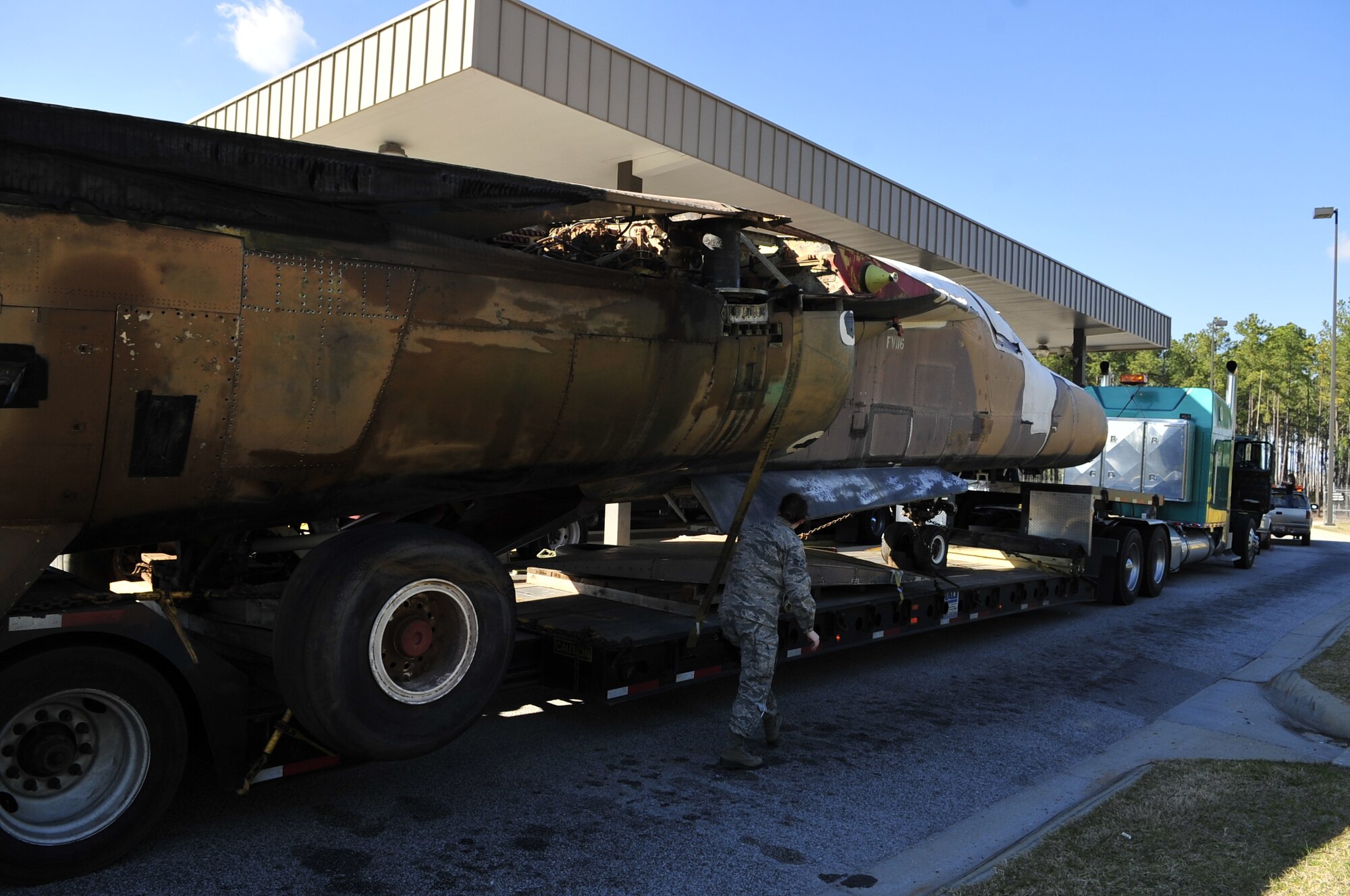 SHAW AIR FORCE BASE, S.C. - U. S. Air Force Senior Airman Angela Holt, a native of Wayne, N.J. and a member of the 20th Security Forces Squadron performs a security check on a truck transporting an F-111E Aardvark that will be used as a static display while at Shaw AFB, S.C. on Feb. 2, 2012.  The Aardvark will be assembled over a four-month period and then there will be a dedication ceremony. (U.S.  Air Force photo/Master Sgt. Cohen A. Young)