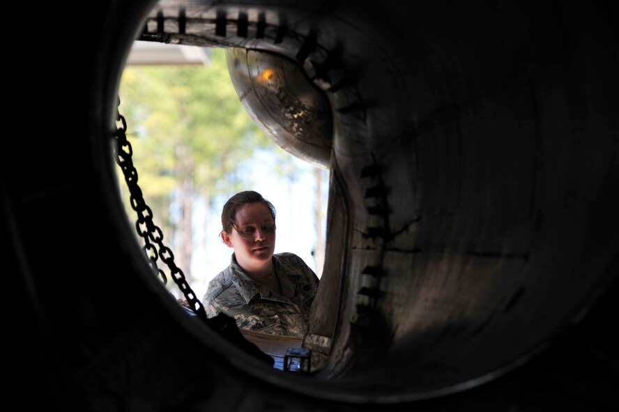 SHAW AIR FORCE BASE, S.C. - U. S. Air Force Senior Airman Angela Holt, a native of Wayne, N.J. and a member of the 20th Security Forces Squadron checks all openings of an F-111E Aardvark that will be used as a static display during a security check while at Shaw AFB, S.C. on Feb. 2, 2012.  The Aardvark will be assembled over a four-month period and then there will be a dedication ceremony. (U.S.  Air Force photo/Master Sgt. Cohen A. Young)