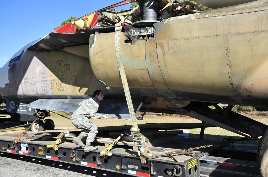 SHAW AIR FORCE BASE, S.C. - U. S. Air Force Senior Airman Angela Holt, a native of Wayne, N.J. and a member of the 20th Security Forces Squadron checks every crevice of an F-111E Aardvark that will be used as a static display during a security check while at Shaw AFB, S.C. on Feb. 2, 2012.  The Aardvark will be assembled over a four-month period and then there will be a dedication ceremony. (U.S.  Air Force photo/Master Sgt. Cohen A. Young)