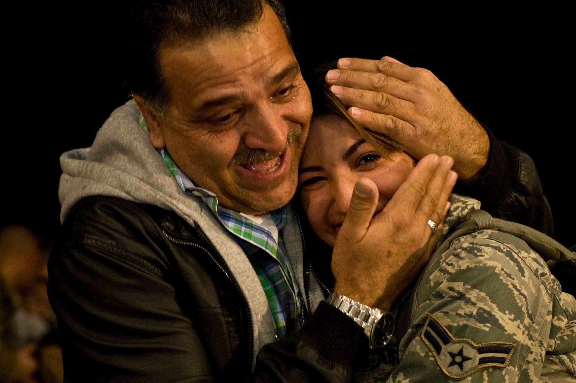 U.S. Air Force Airman 1st Class Denise Figueroa-Guarneros, 57th Maintenance Squadron maintainer, is embraced by her father during a homecoming celebration Feb. 8, 2012, inside the 763rd Rescue Maintenance Squadron hangar on Nellis Air Force Base, Nev.  The returning 71 Airmen, most of whom are assigned to either the 66th Rescue Squadron or the 763rd Rescue Maintenance Squadron, comprised the last Air Force rescue unit stationed in Iraq prior to the withdrawal of U.S. forces in December 2011. (U.S. Air Force photo by Airman 1st Class Daniel Hughes)