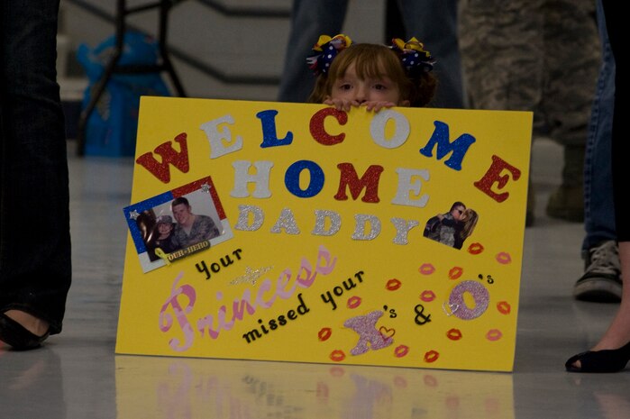 An Airman's daughter waits for her father during a homecoming celebration Feb. 8, 2012, inside the 763rd Rescue Maintenance Squadron hangar on Nellis Air Force Base, Nev.  The returning 71 Airmen, most of whom are assigned to either the 66th Rescue Squadron or the 763rd Rescue Maintenance Squadron, comprised the last Air Force rescue unit stationed in Iraq prior to the withdrawal of U.S. forces in December 2011. (U.S. Air Force photo by Airman 1st Class Daniel Hughes)