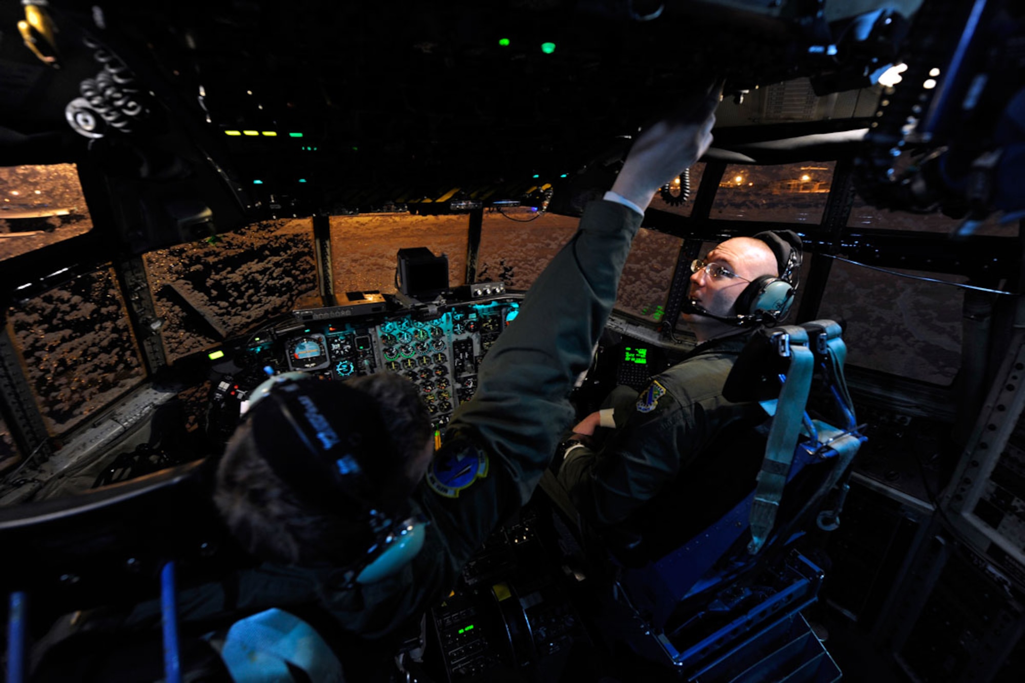 Staff Sgt. Ryan Lilly and Tech. Sgt. Brian Davis pre-flight a C-130H Hercules before takeoff from Joint Base Elmendorf-Richardson. Lilly and Davis are assigned to the 537th Airlift Squadron here. (U.S. Air Force photo/Tech Sgt. Brian Ferguson)